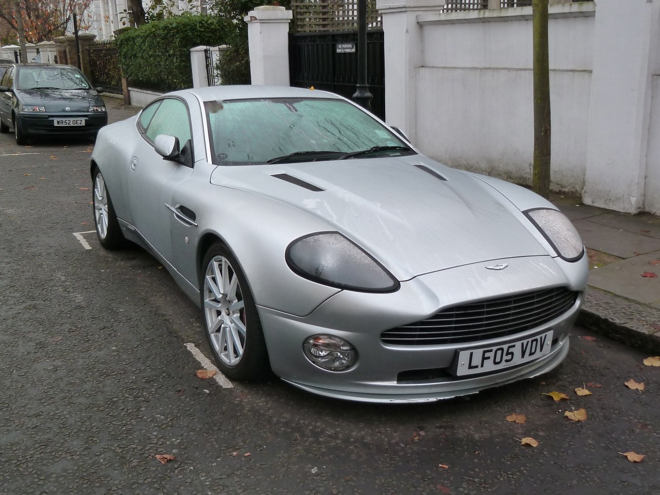Silver sports coupe with vented hood and alloy wheels
