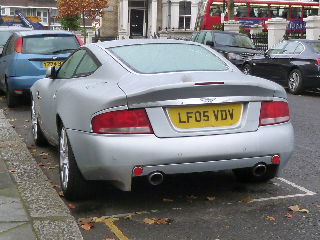 Silver rear view of luxury coupe showing taillights and dual exhaust