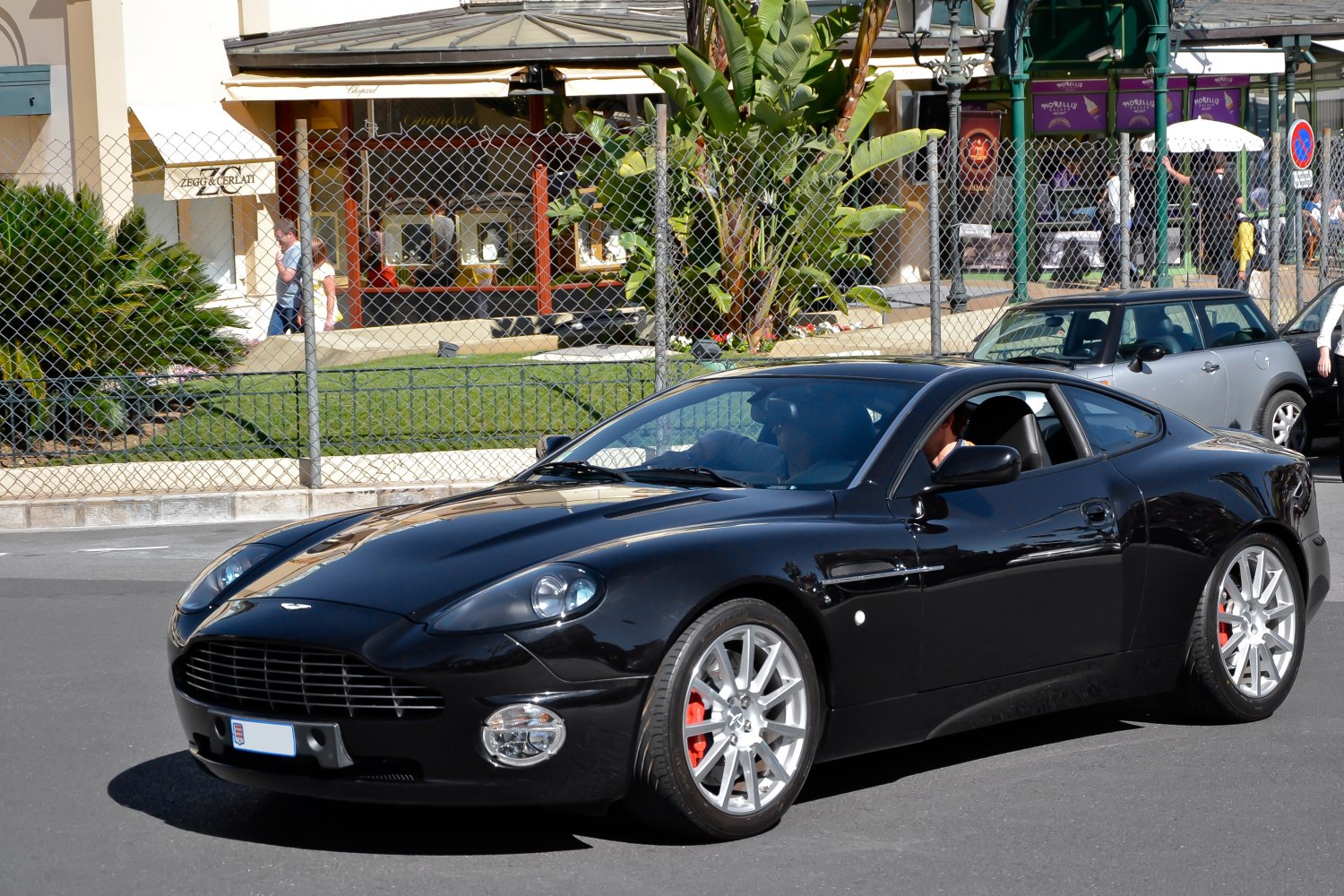 Black sports coupe with silver wheels and prominent front grille
