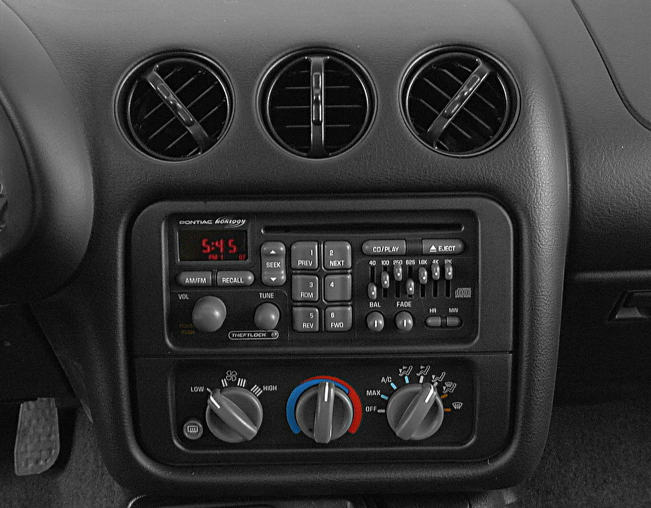 Car dashboard center console with radio and climate control knobs