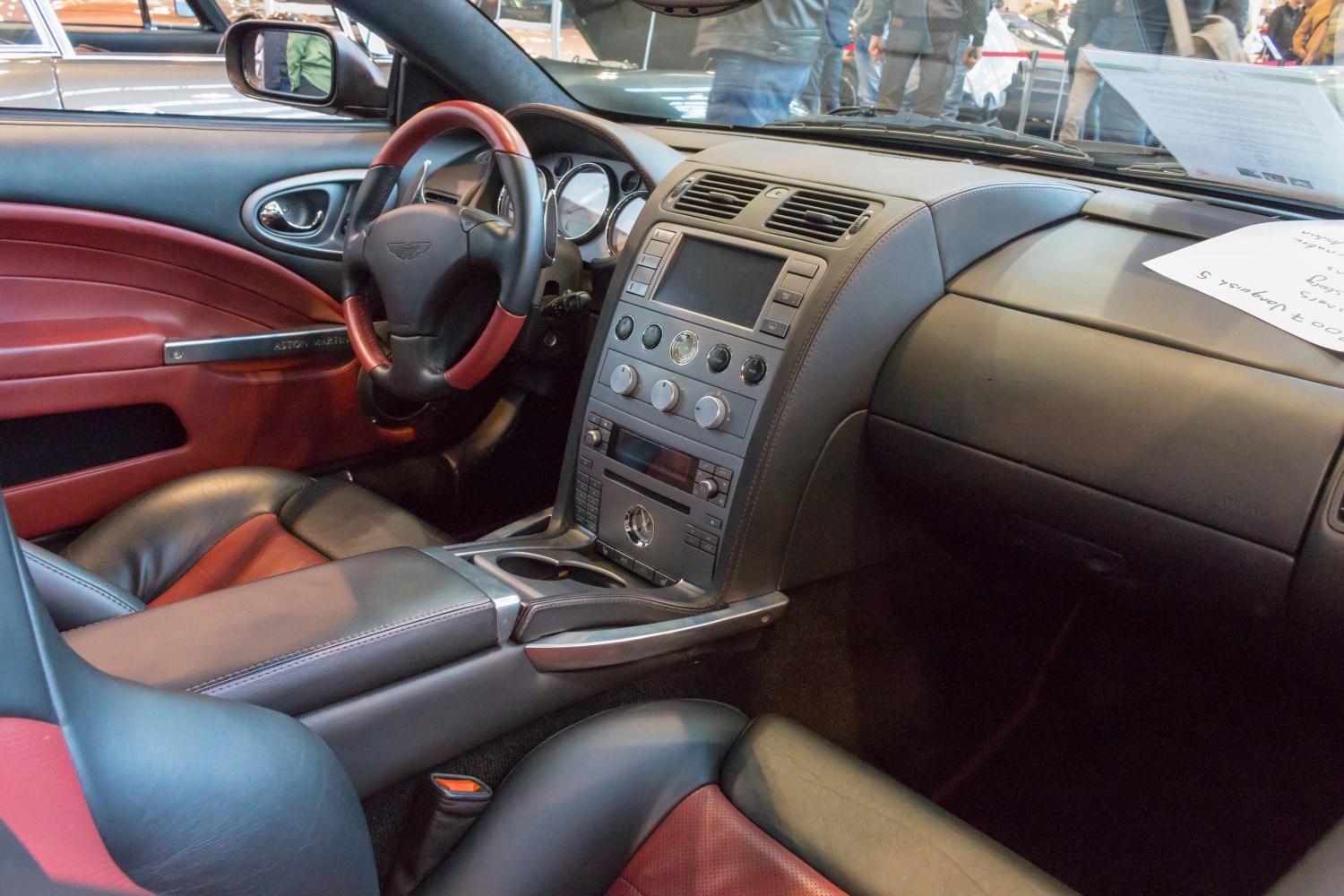 Black and red leather interior with detailed dashboard and steering wheel