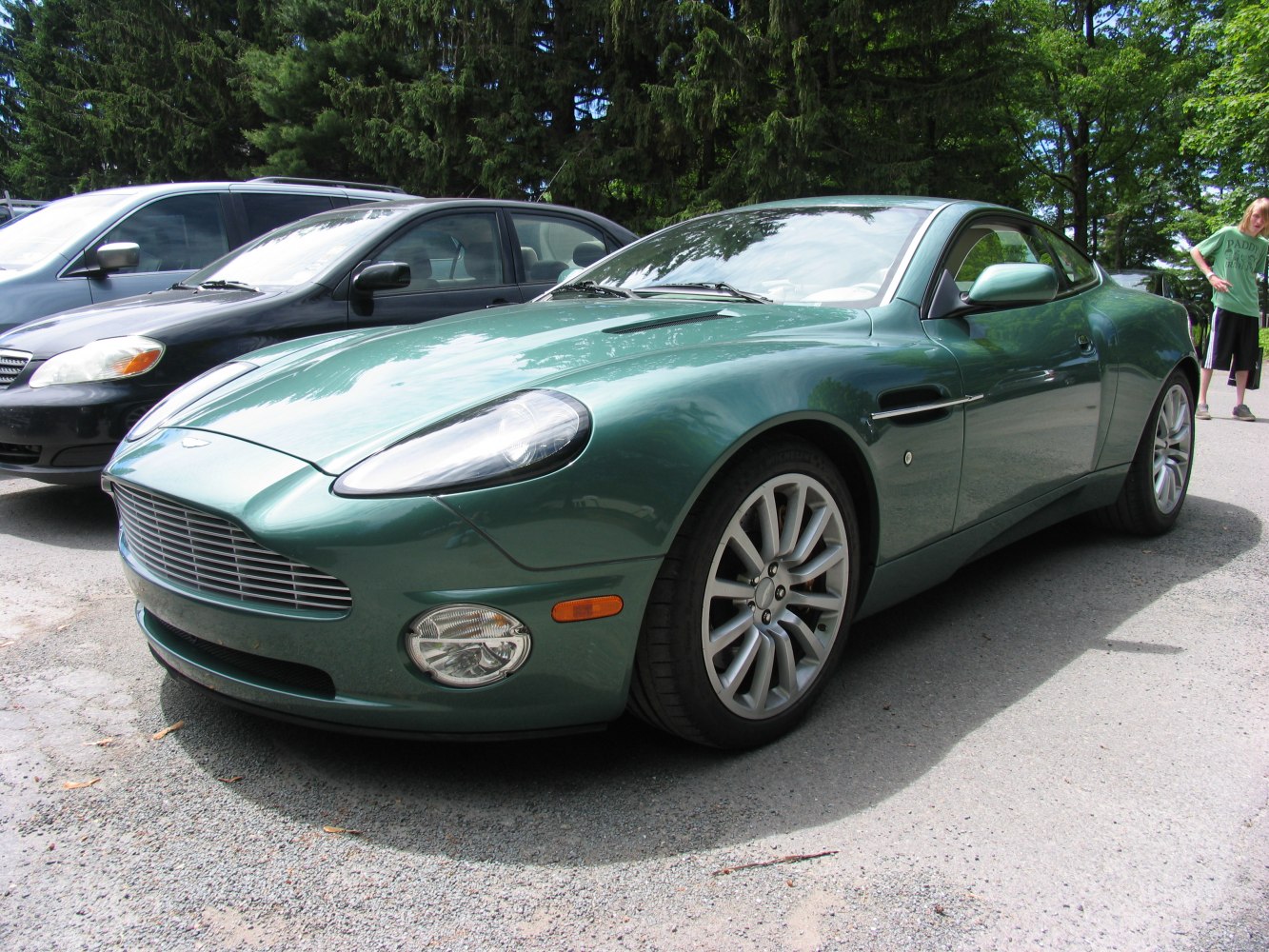 Front 3/4 view of green sporty coupe with alloy wheels and distinctive grille