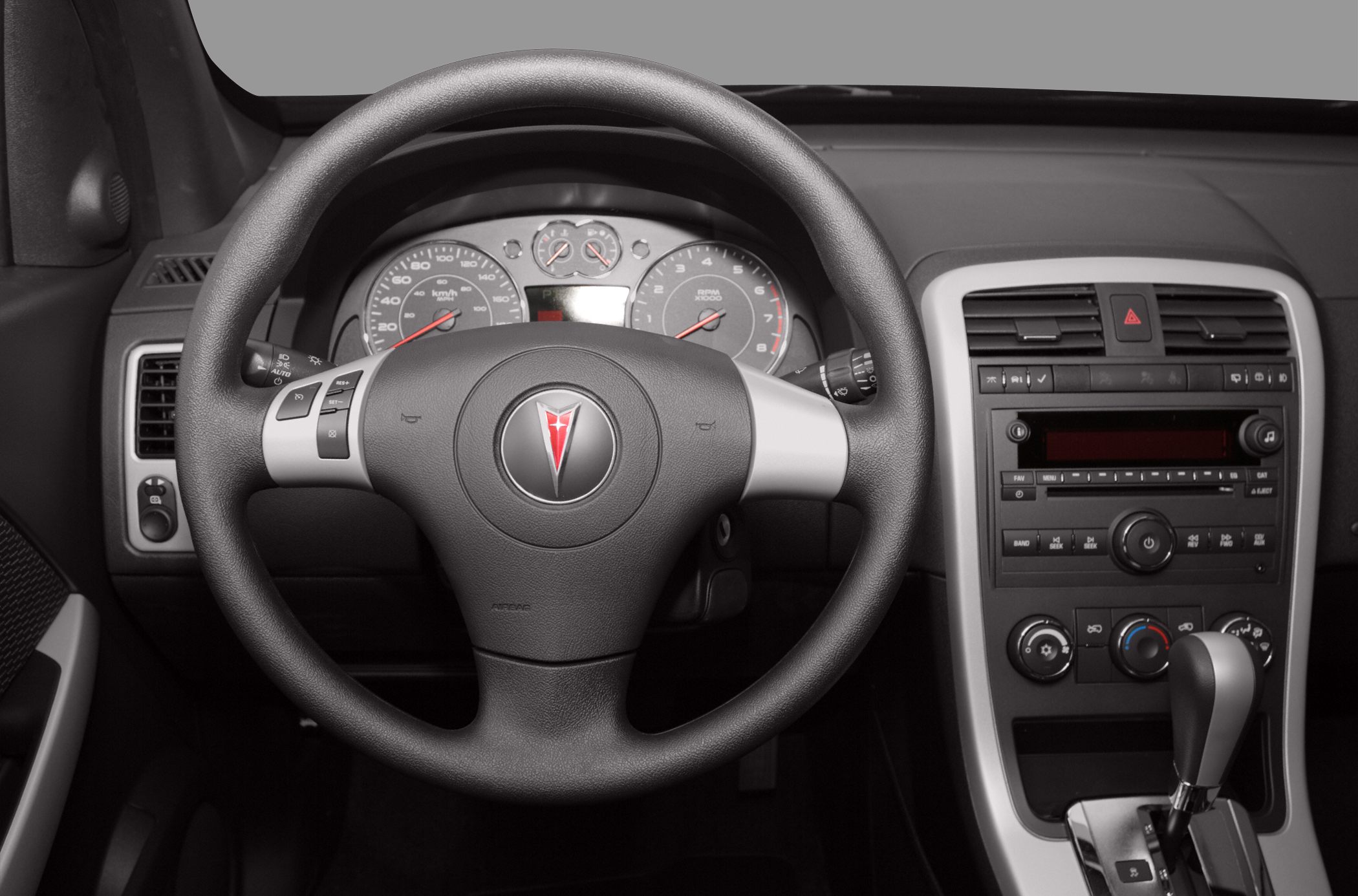 Steering wheel and dashboard with instrument cluster and center console controls