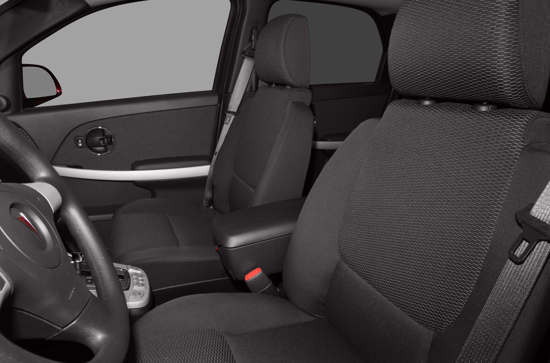 Front seats, door panel, seatbelt, and center armrest in car interior