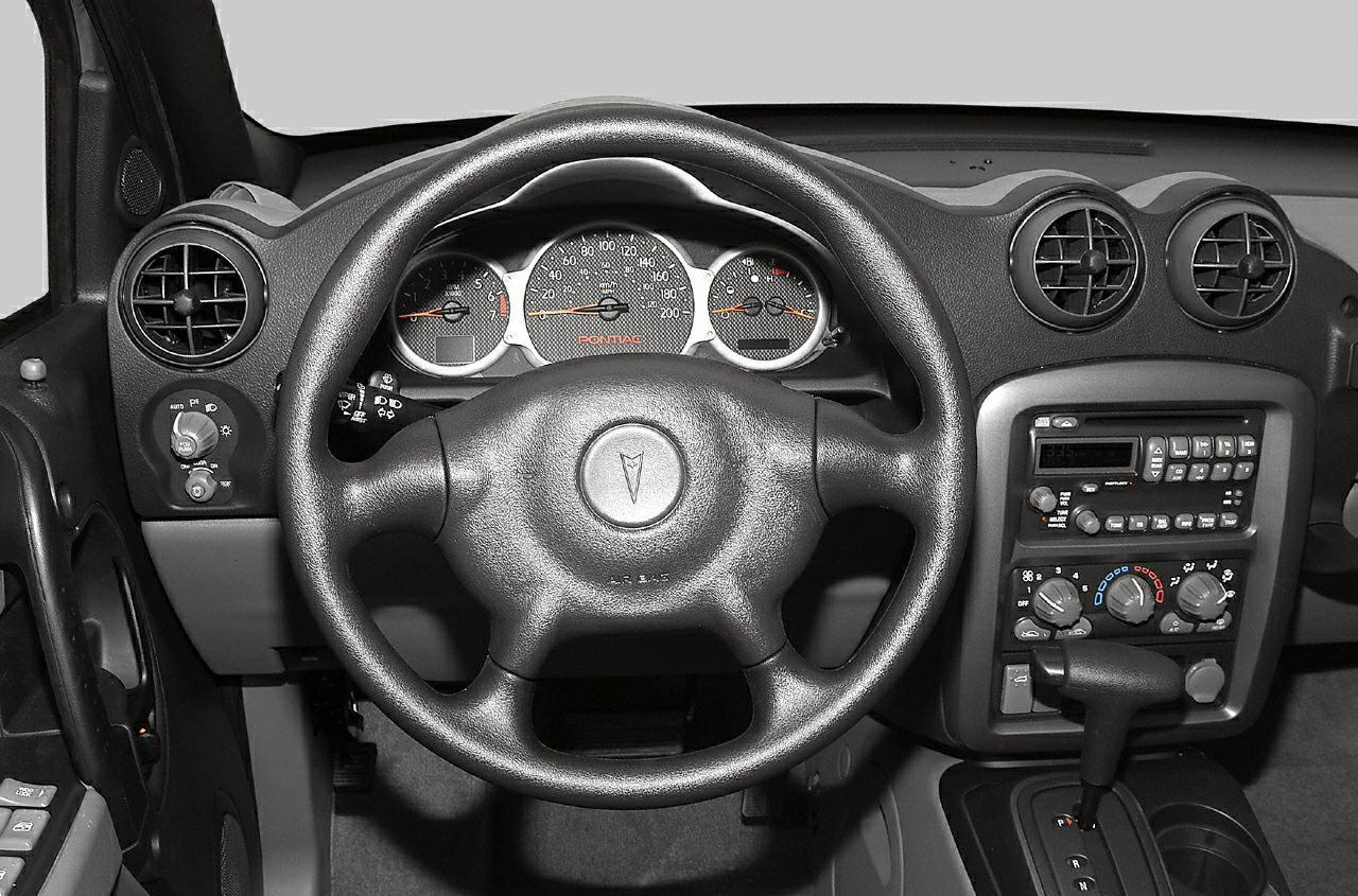 Dashboard, steering wheel, and central control panel with gear shifter