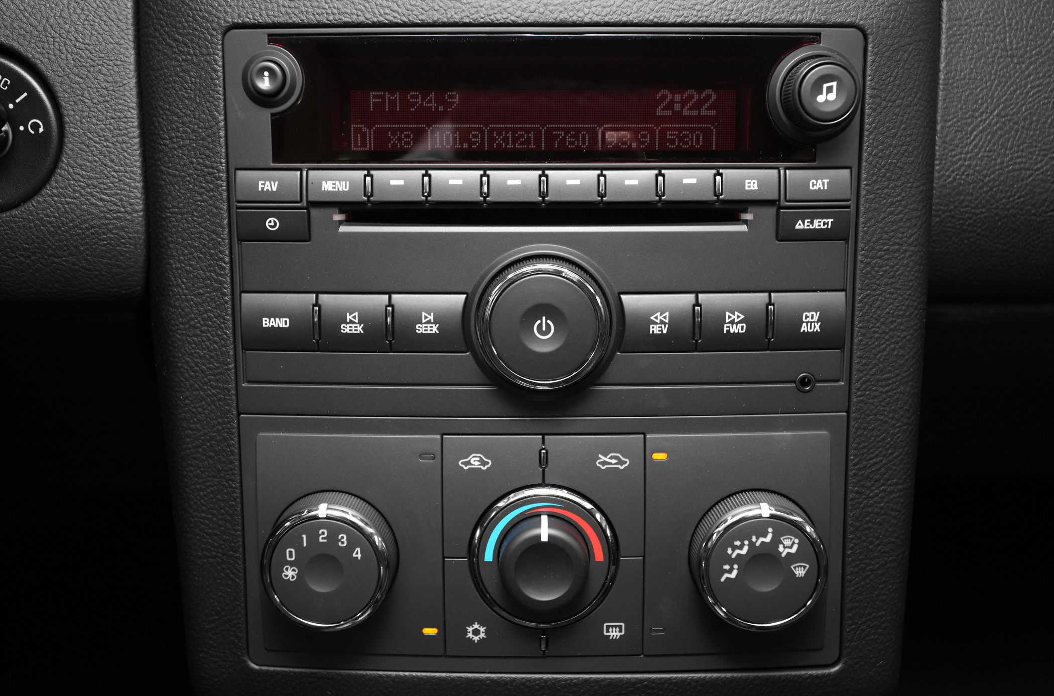 Car stereo system and climate control knobs with display screen and buttons.
