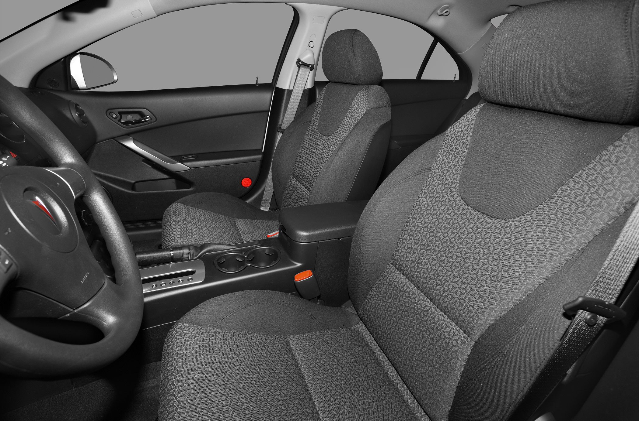 Front seats, steering wheel, and center console with cup holders