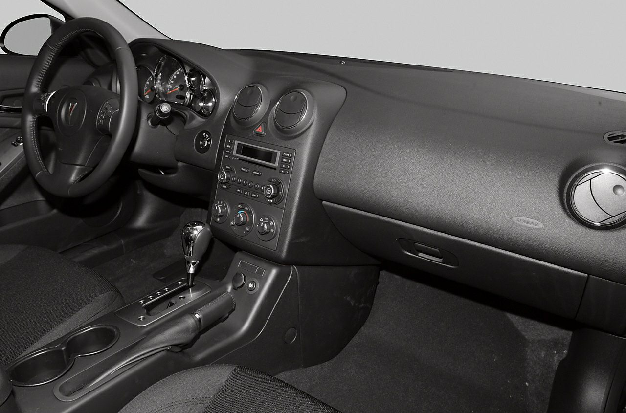 Interior dashboard and center console with steering wheel and automatic gear shifter