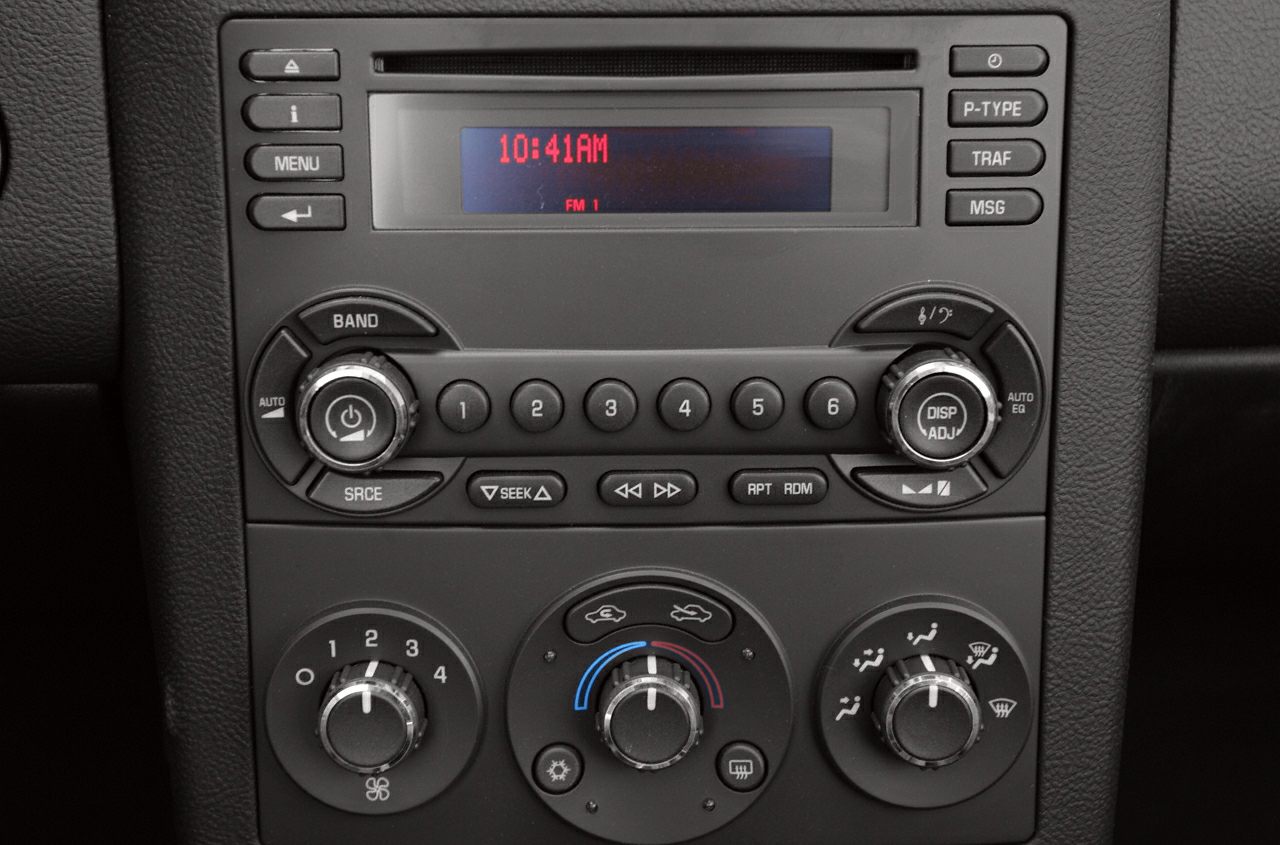 Classic car radio and climate control panel with analog buttons and dials