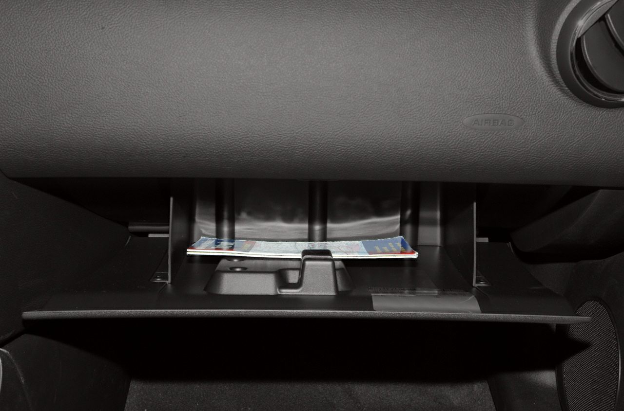 Open glove compartment with documents stored inside