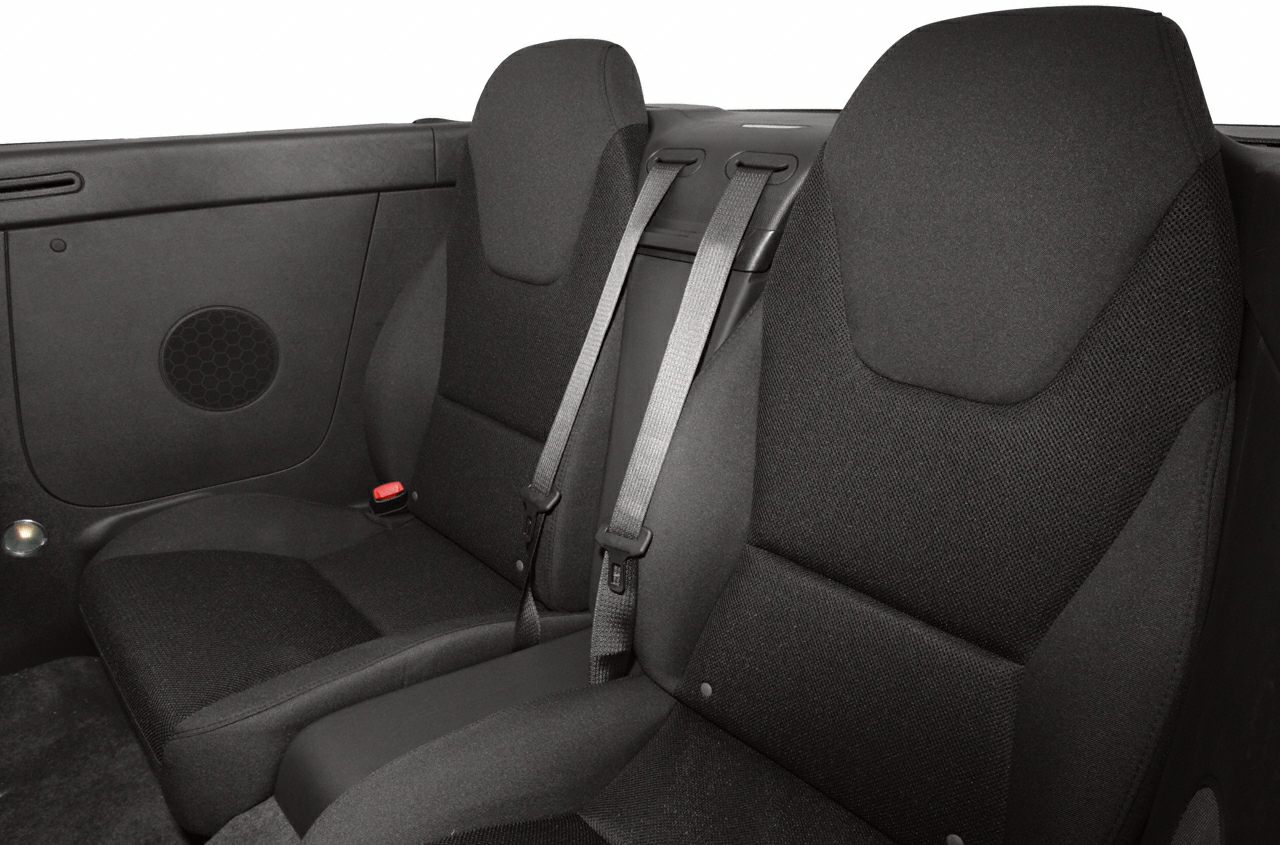 Rear passenger seats with seatbelts in a convertible car interior