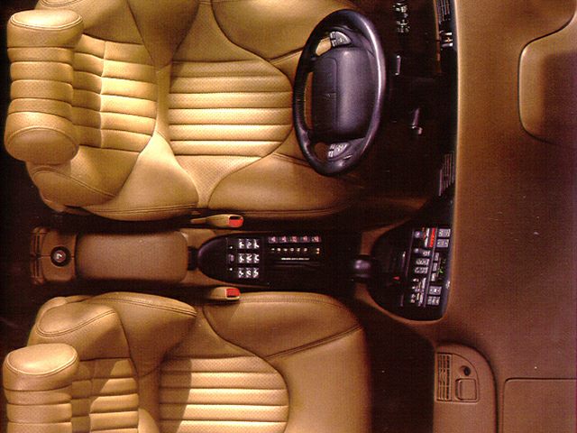 Top view of leather seats and steering wheel with center console.