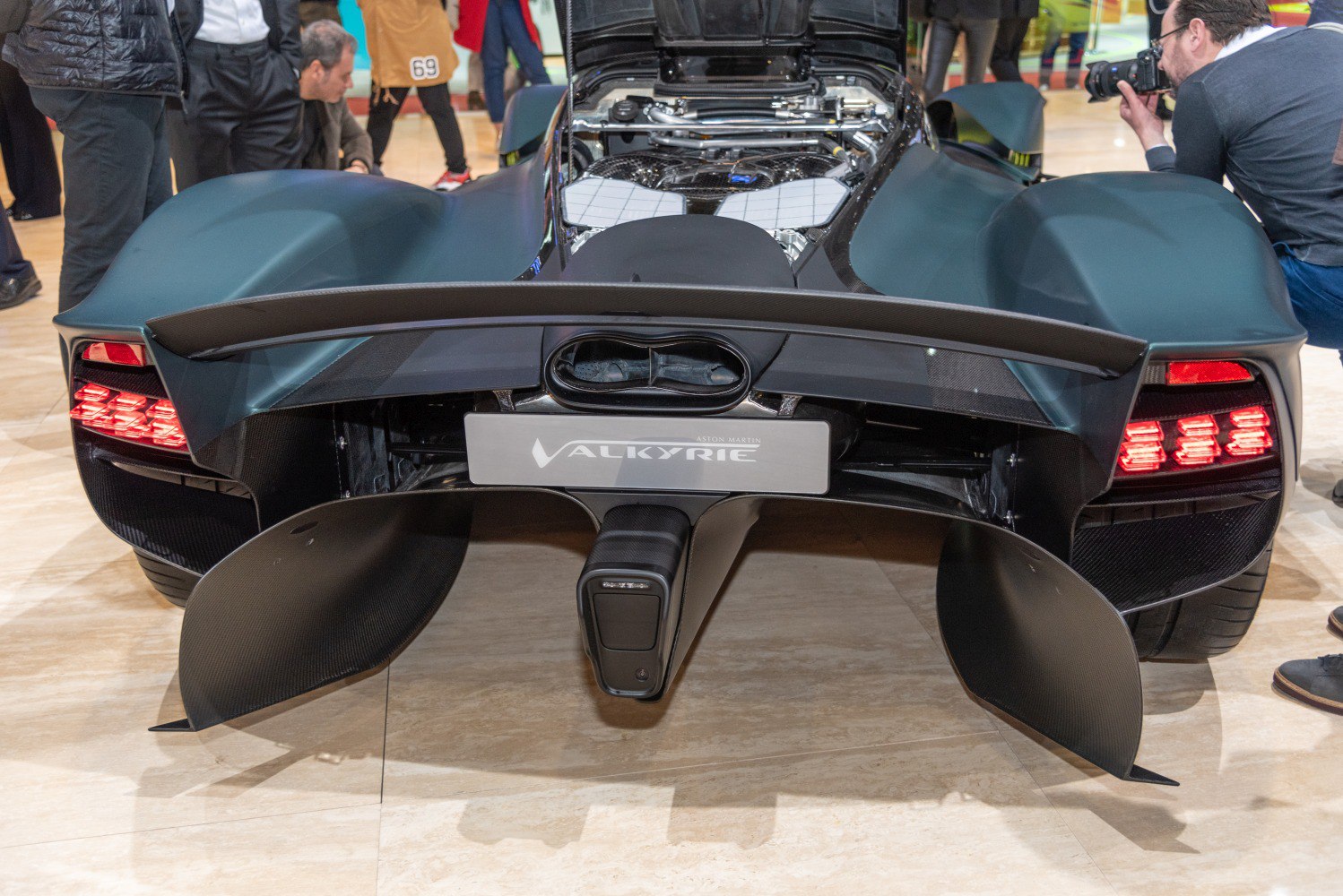 Aerodynamic rear wing and exposed engine bay with rear diffuser and taillights