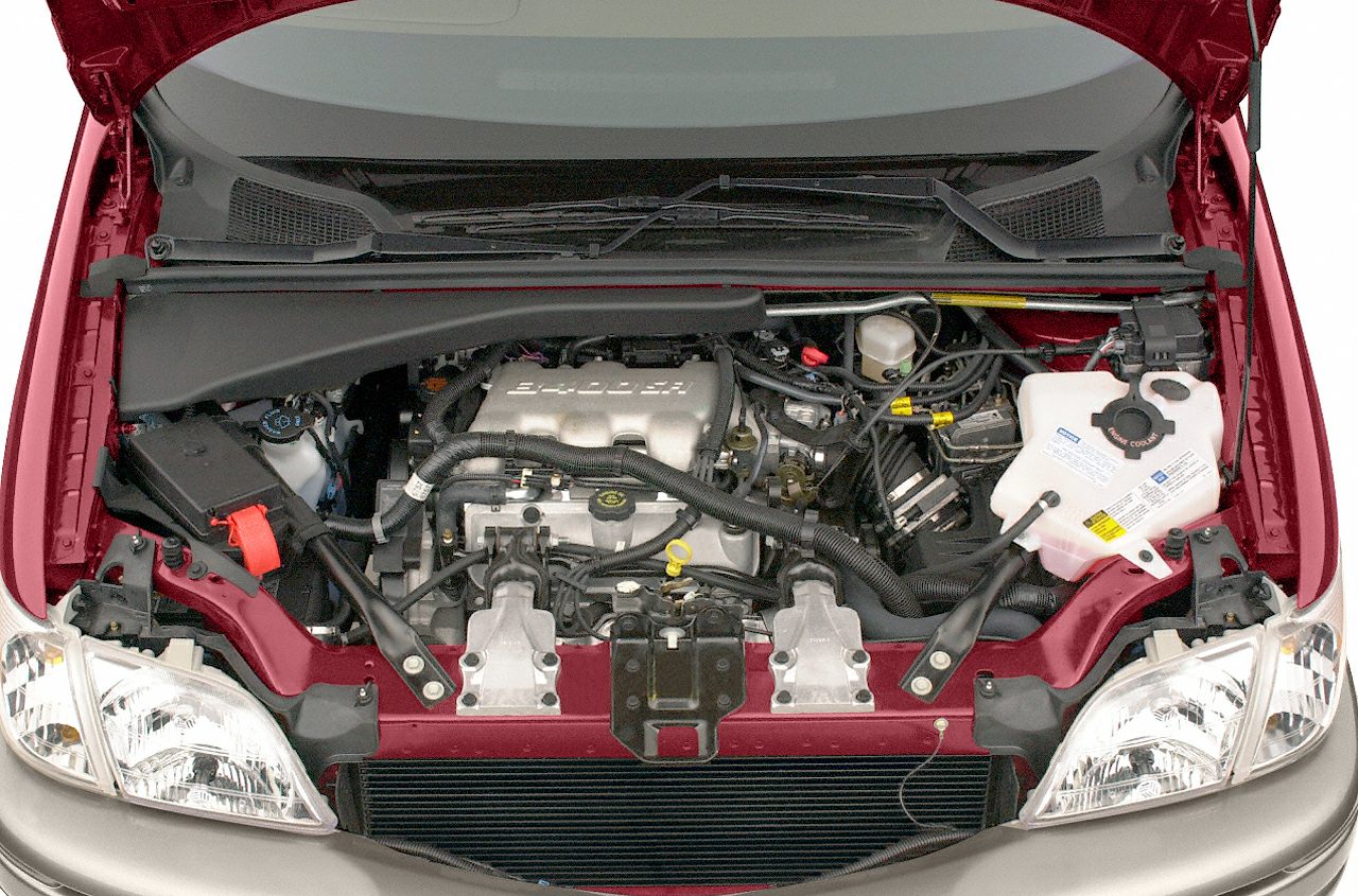 Engine compartment with visible intake manifold, battery, and fluid reservoirs