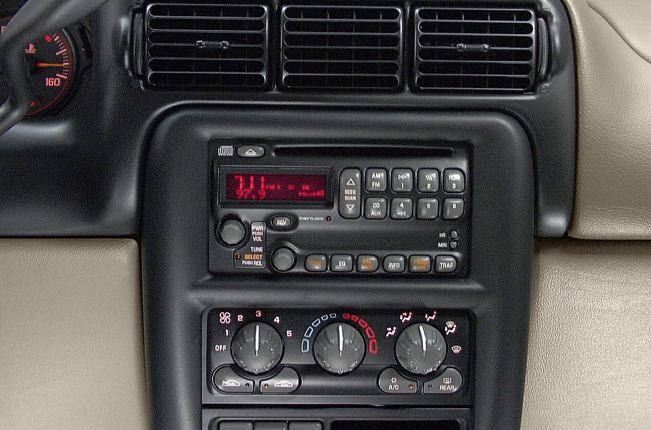 Car dashboard with vintage radio and rotary HVAC controls