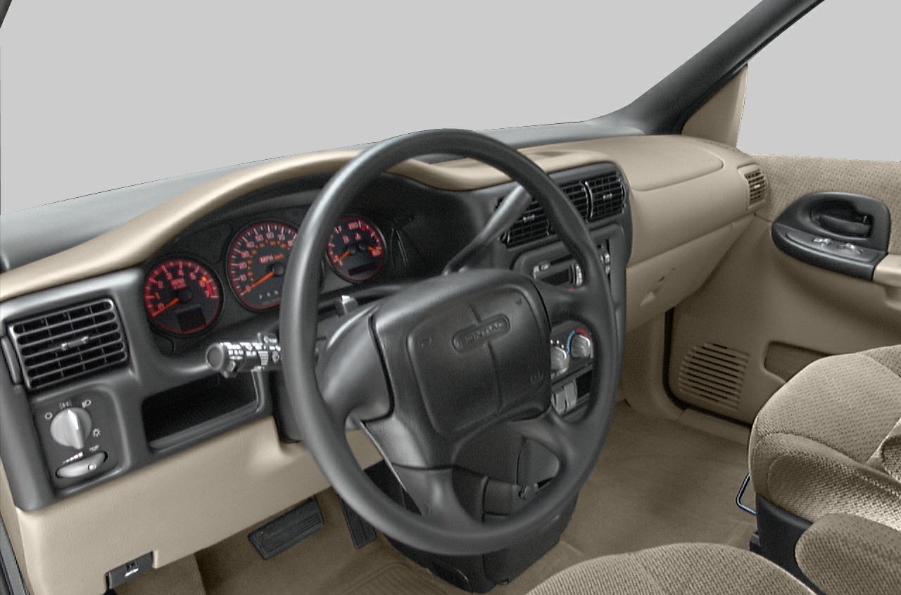 Beige dashboard and steering wheel with instrument cluster and control panel