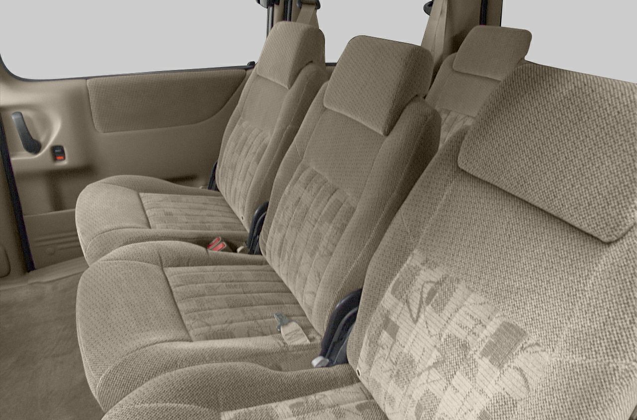 Beige fabric minivan seats with patterned design and headrests