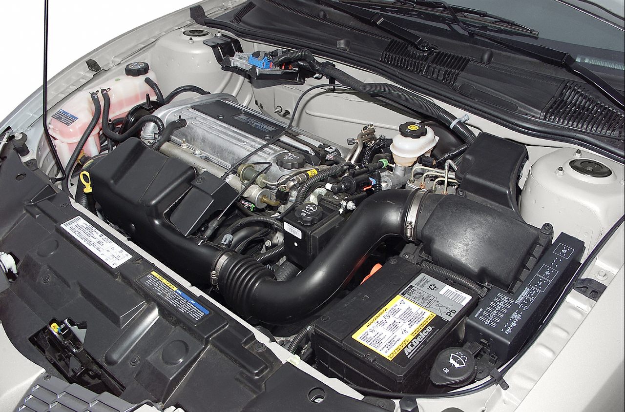 1995 Pontiac Sunfire Coupe engine bay with visible air intake and battery