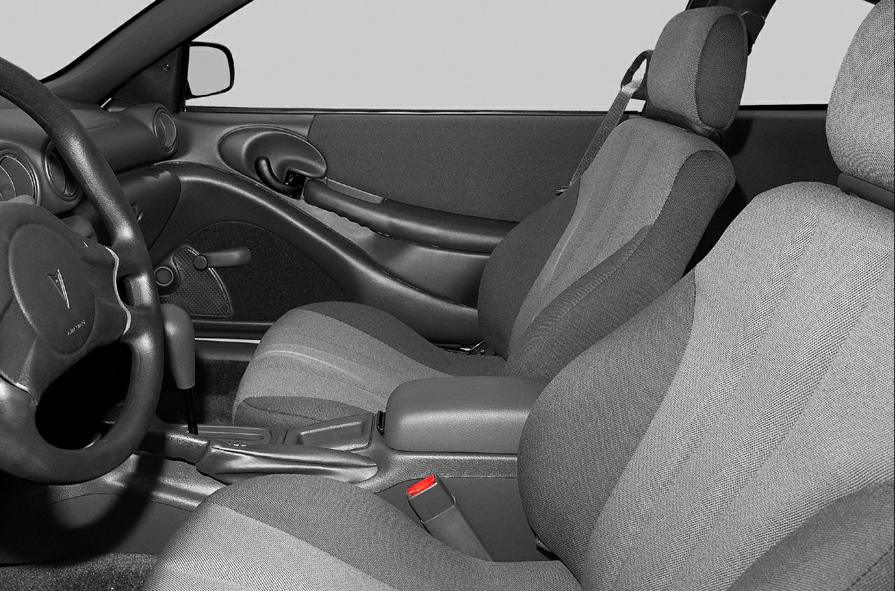 Fabric seats and manual window crank in car interior