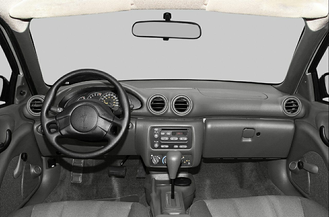Dashboard, steering wheel, center console of a 90s coupe