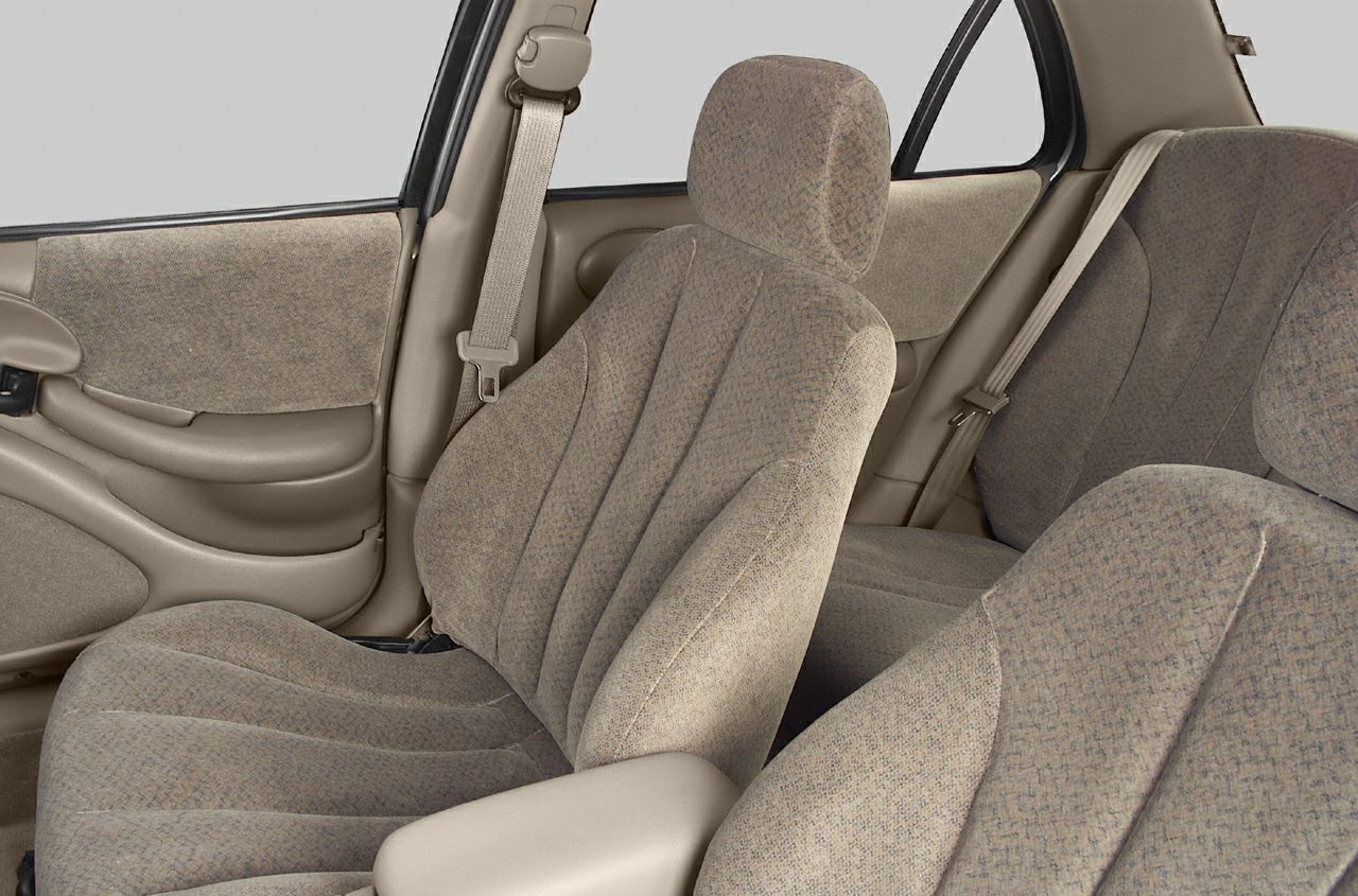 Beige fabric seats and seatbelt details in sedan interior