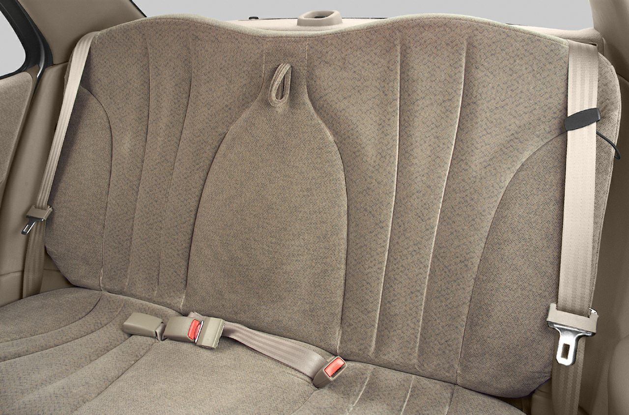 Rear seat fabric upholstery with integrated seat belts in a sedan.