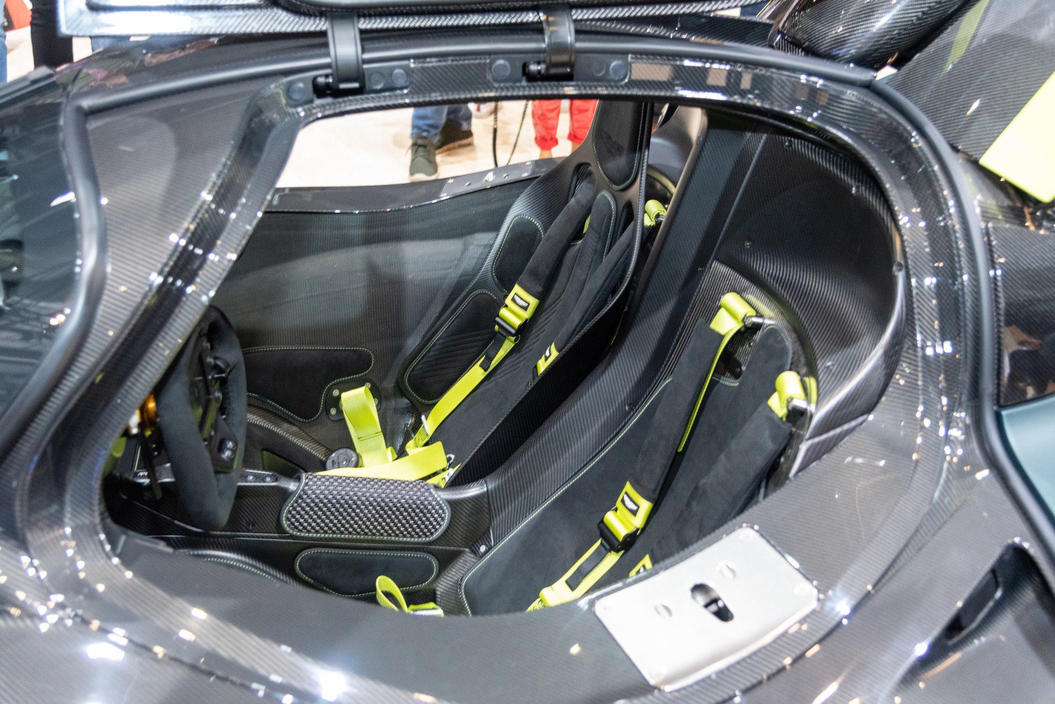 Carbon fiber racing seats with neon yellow harnesses