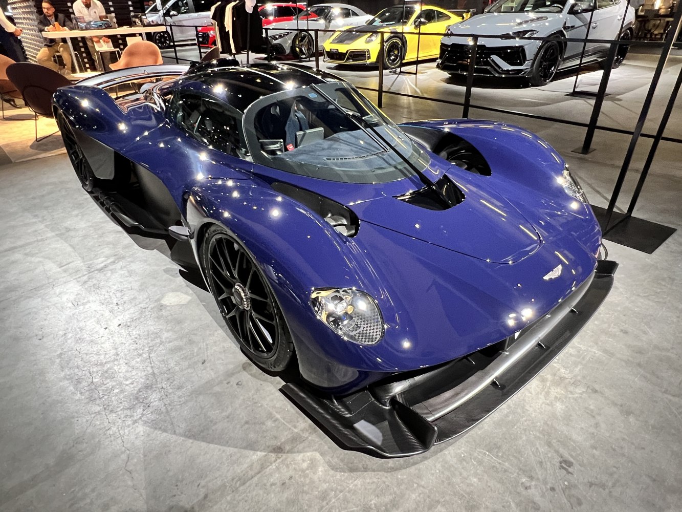 Aerodynamic hypercar front end with carbon fiber splitter and unique headlights
