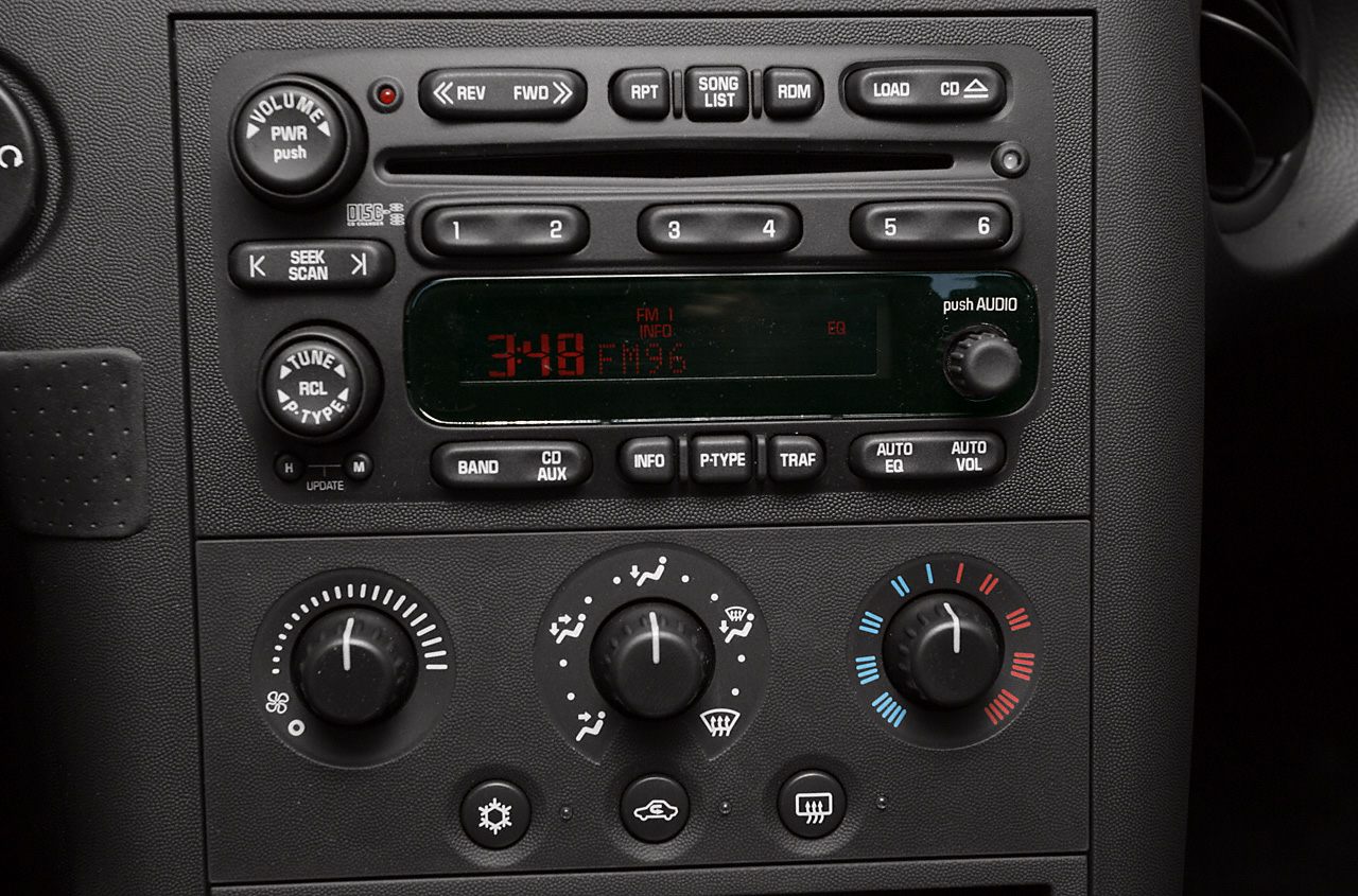 Car audio system and manual climate controls with knobs and buttons
