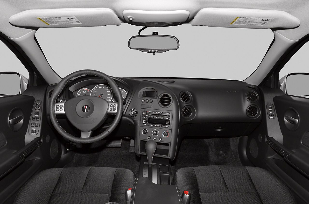 Car interior with dashboard, steering wheel, and center console