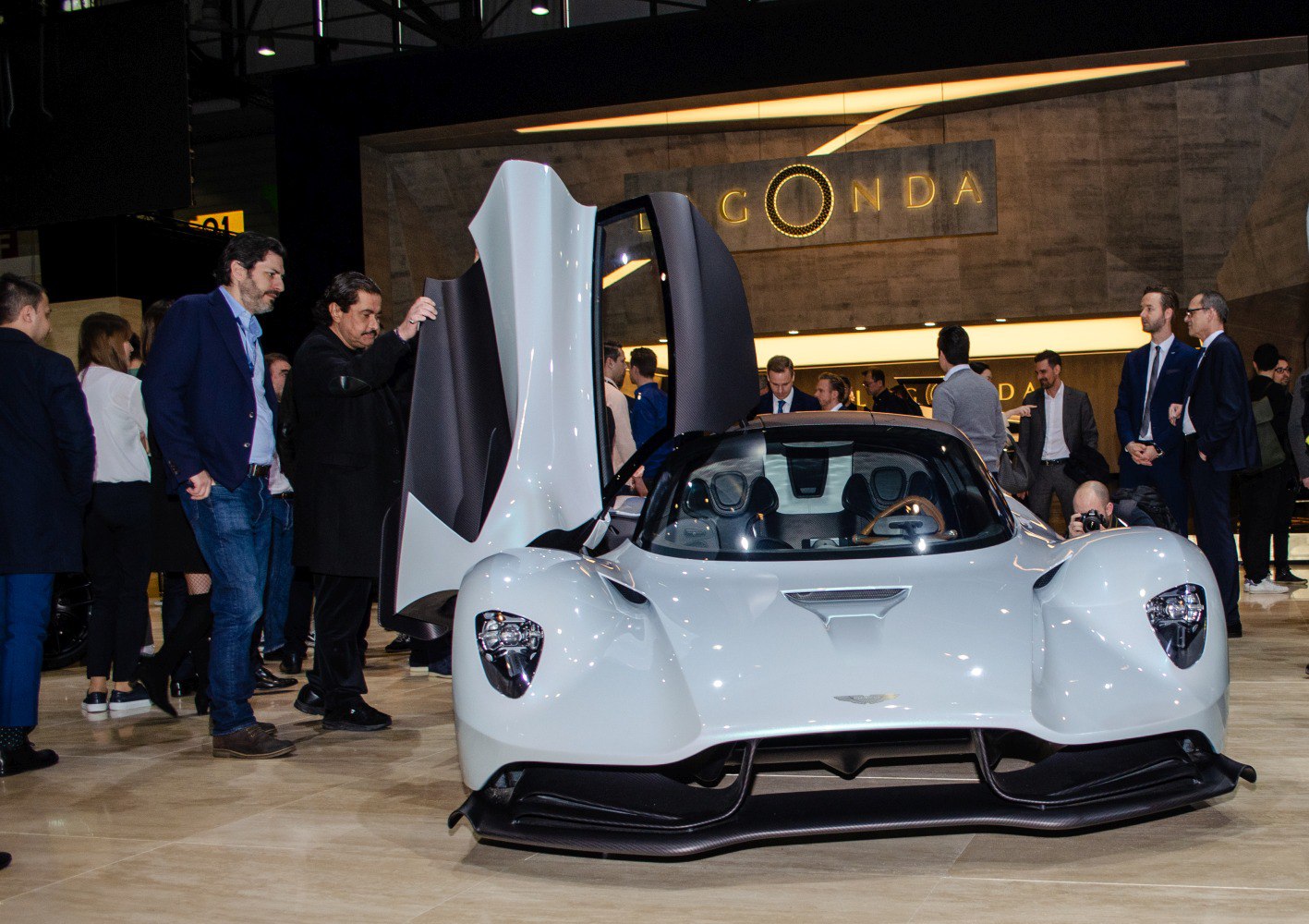 White hypercar with dihedral doors and aerodynamic front design