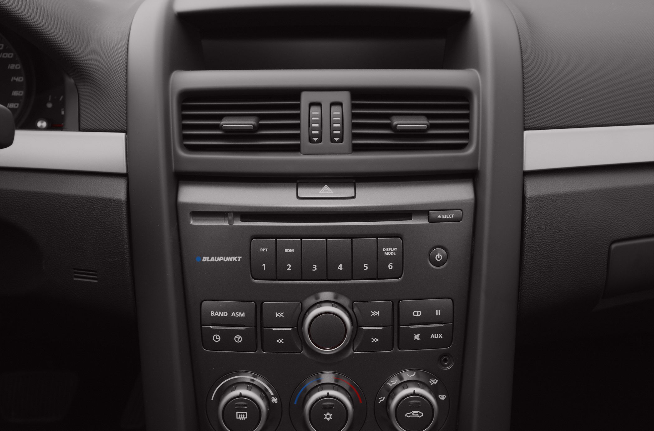 Car interior with radio, air vents, and climate controls