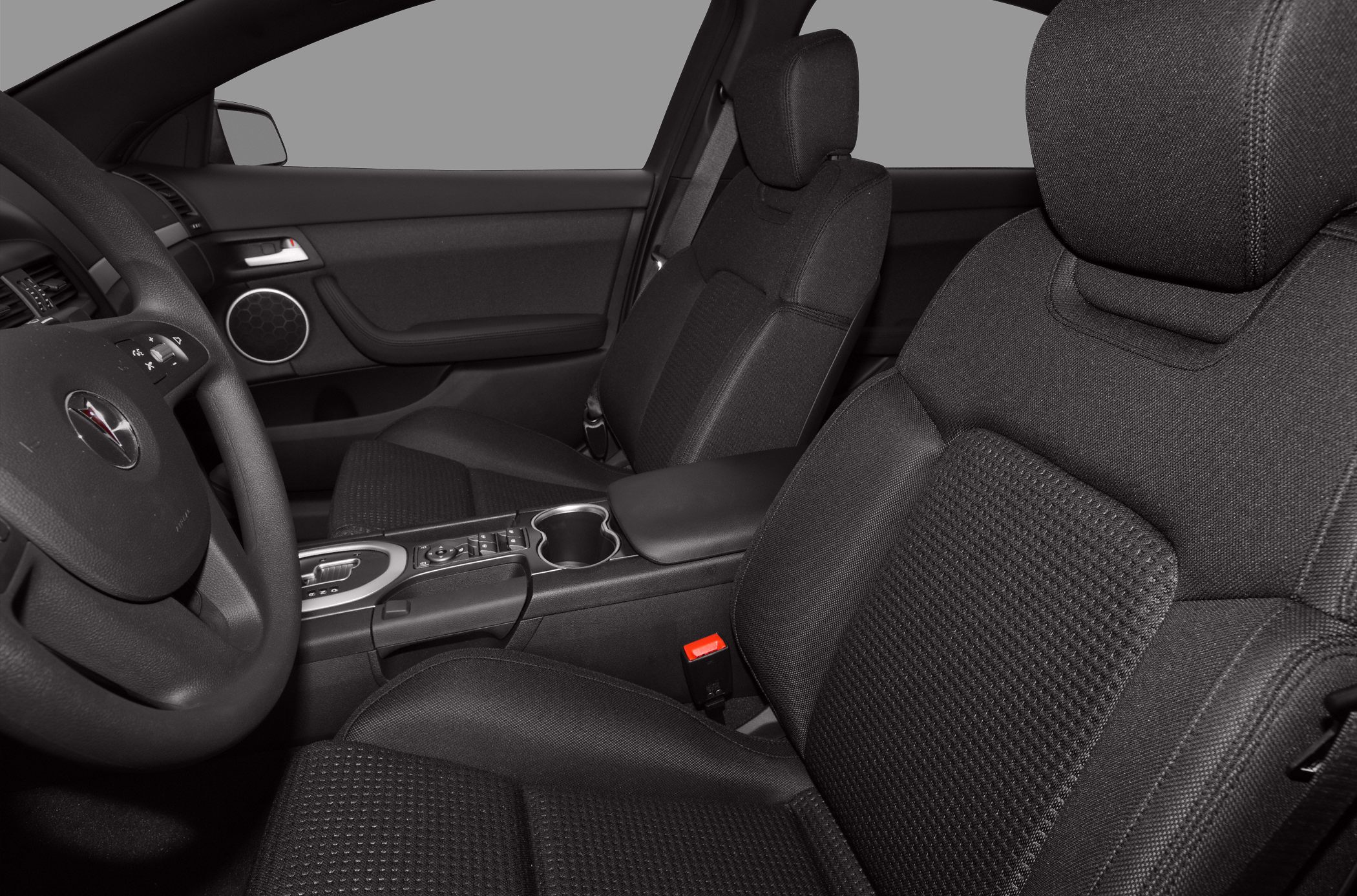 Fabric front seats and center console with steering wheel in car interior