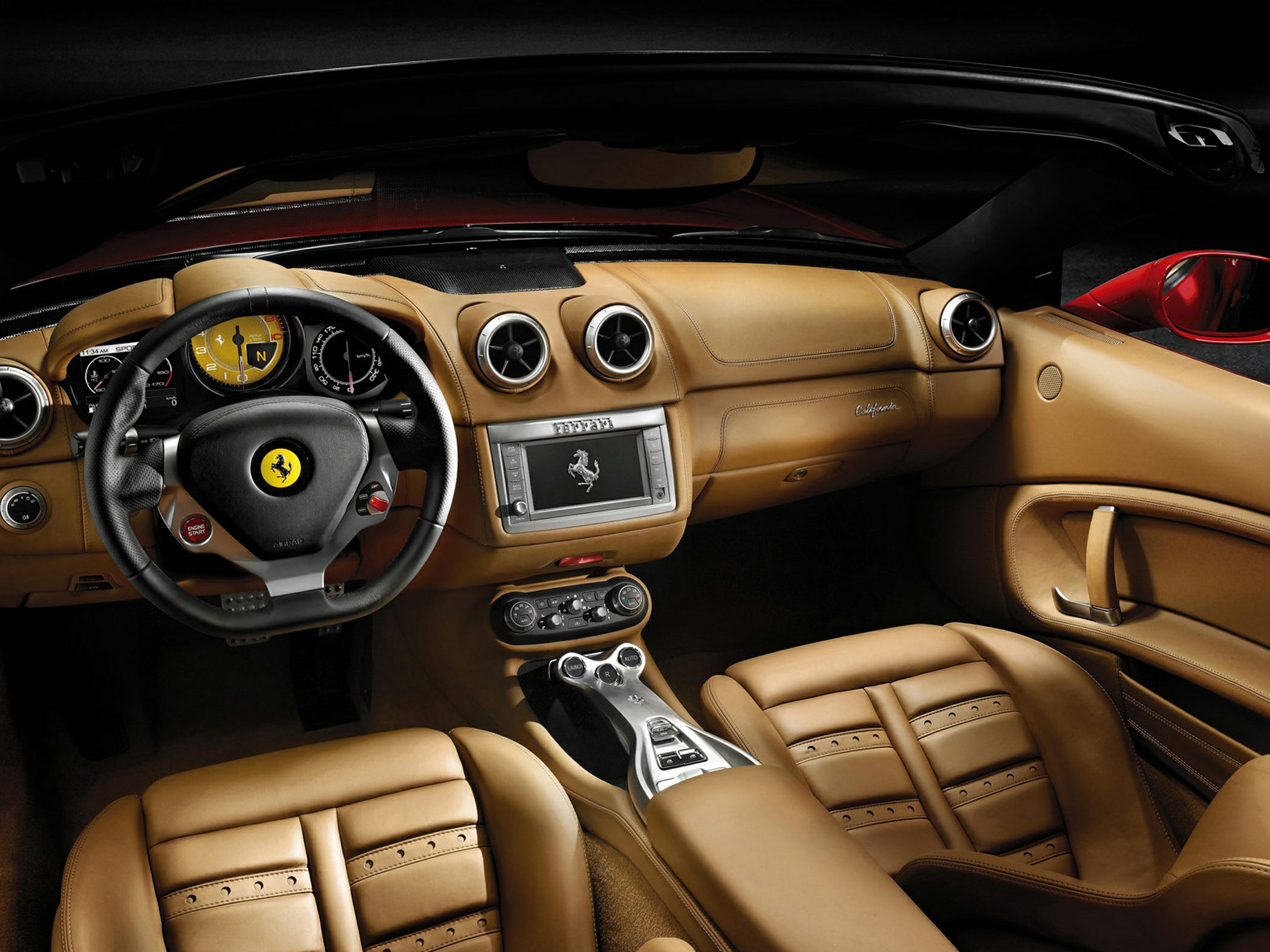 Tan leather interior with sporty steering wheel and detailed dashboard layout