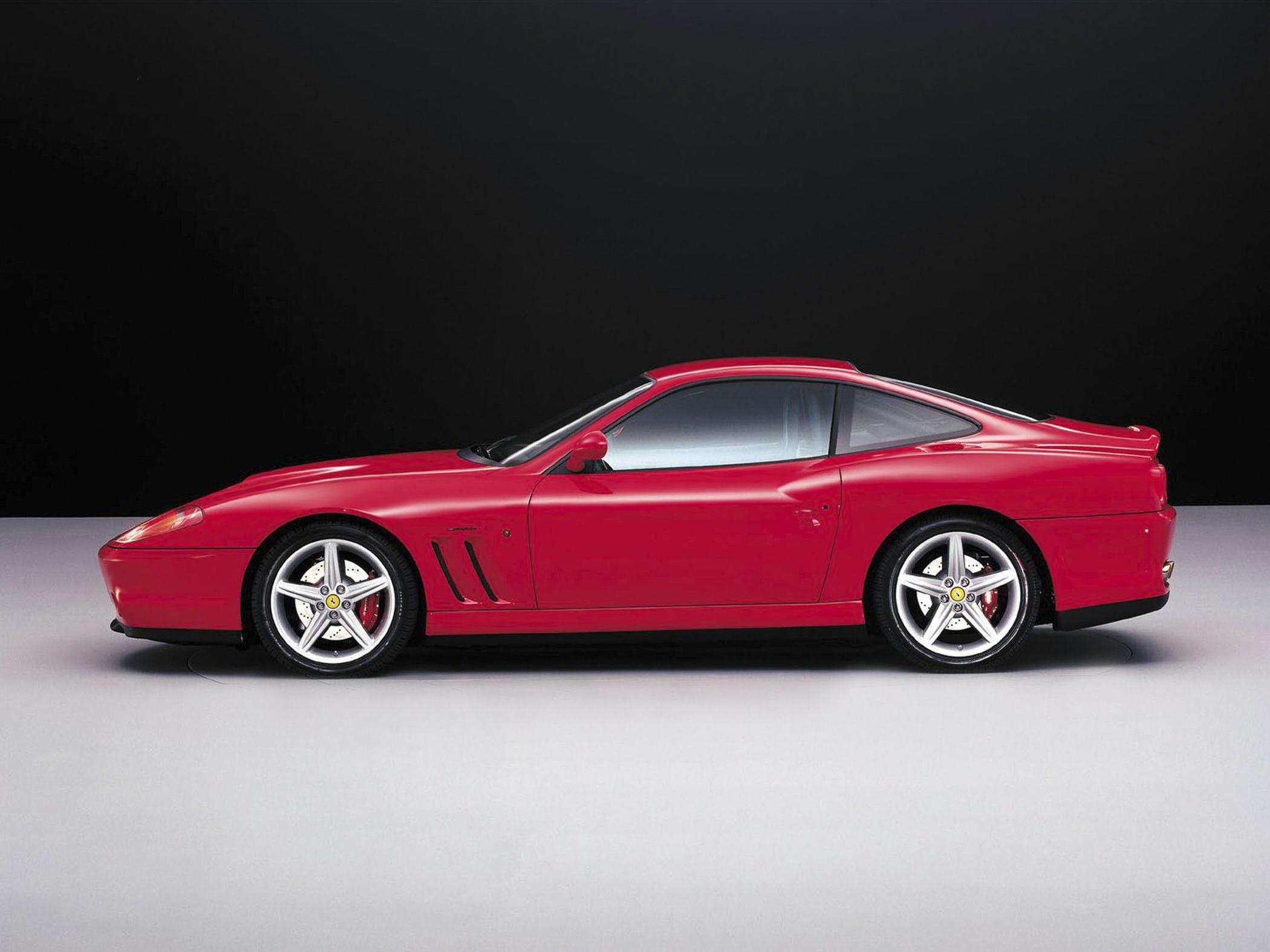 Side view of red sports coupe with aerodynamic design and alloy wheels
