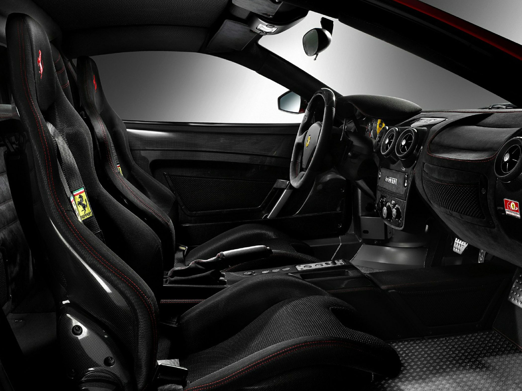 Racing bucket seats and sleek dashboard with performance controls