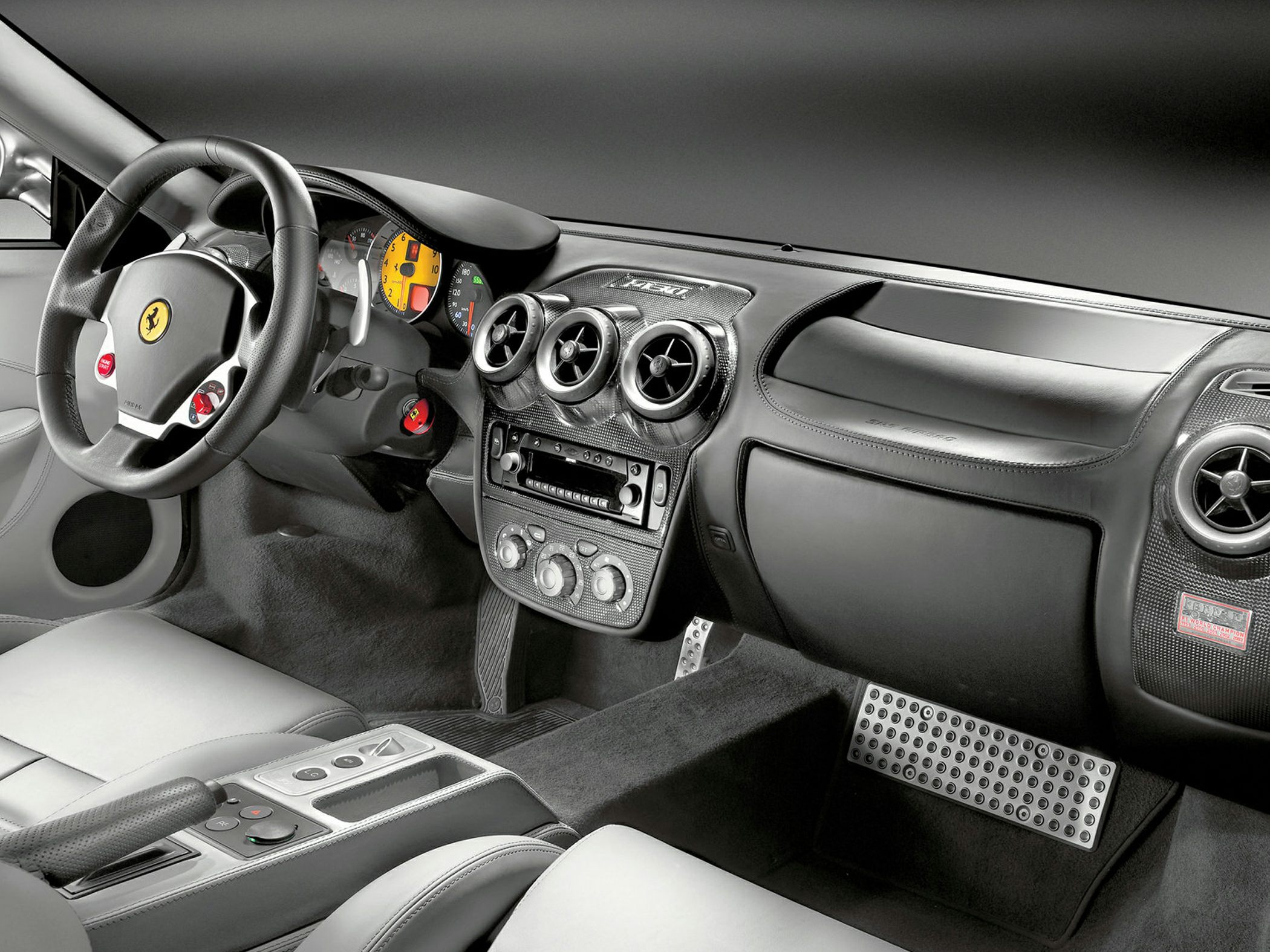 Dashboard, steering wheel with paddle shifters, and central air vents