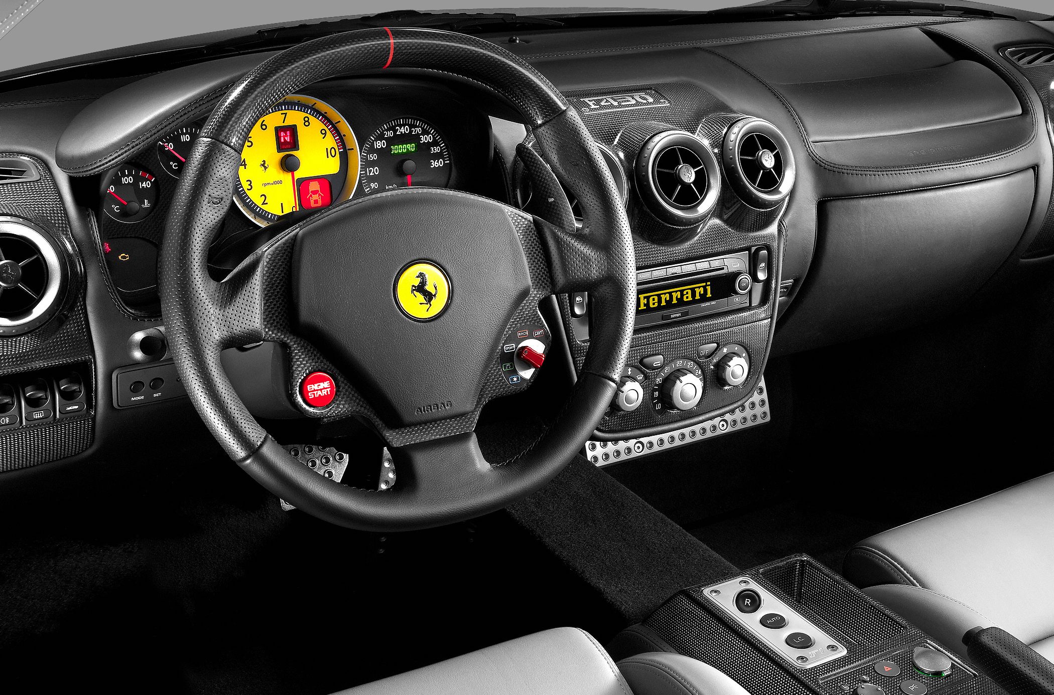 Carbon fiber dashboard and detailed steering wheel with instrument cluster.