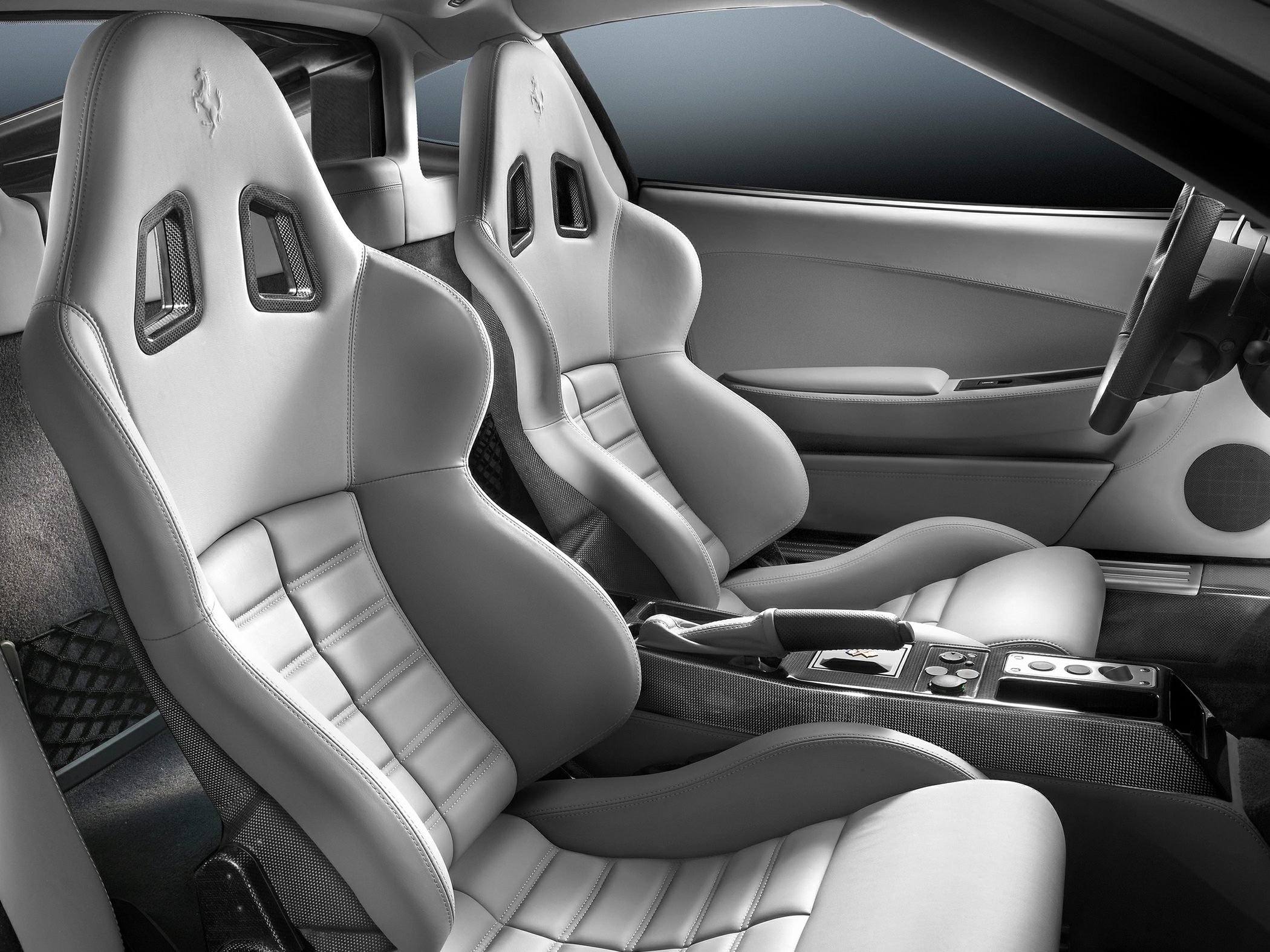 Racing-style bucket seats with leather upholstery and carbon fiber elements.