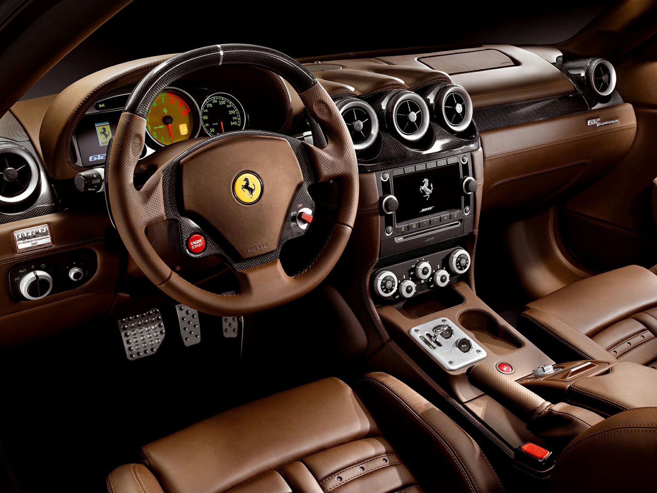 Brown leather interior with carbon fiber steering wheel and advanced dashboard