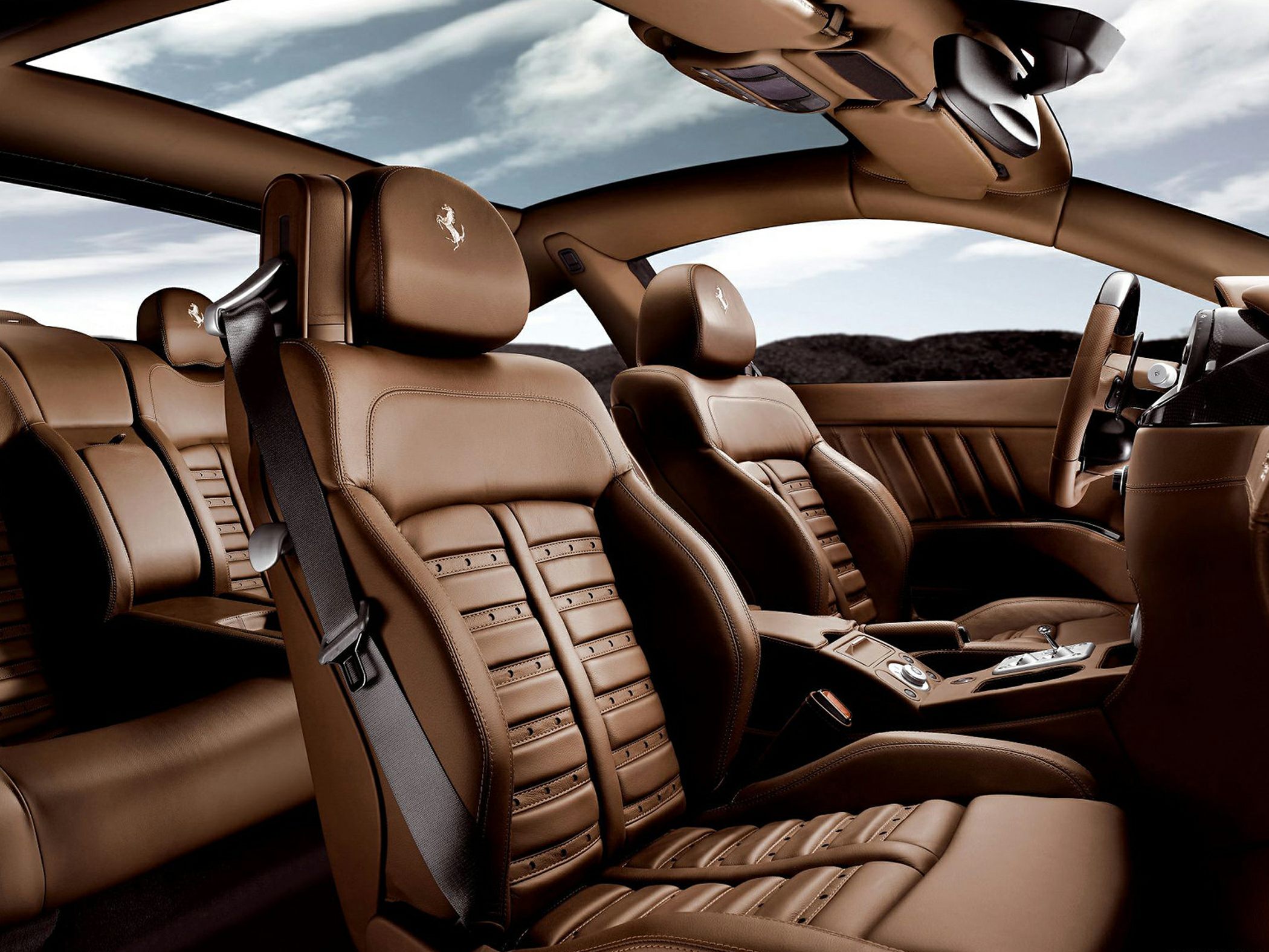 Luxurious brown leather seats with distinctive stitching and Ferrari emblem.
