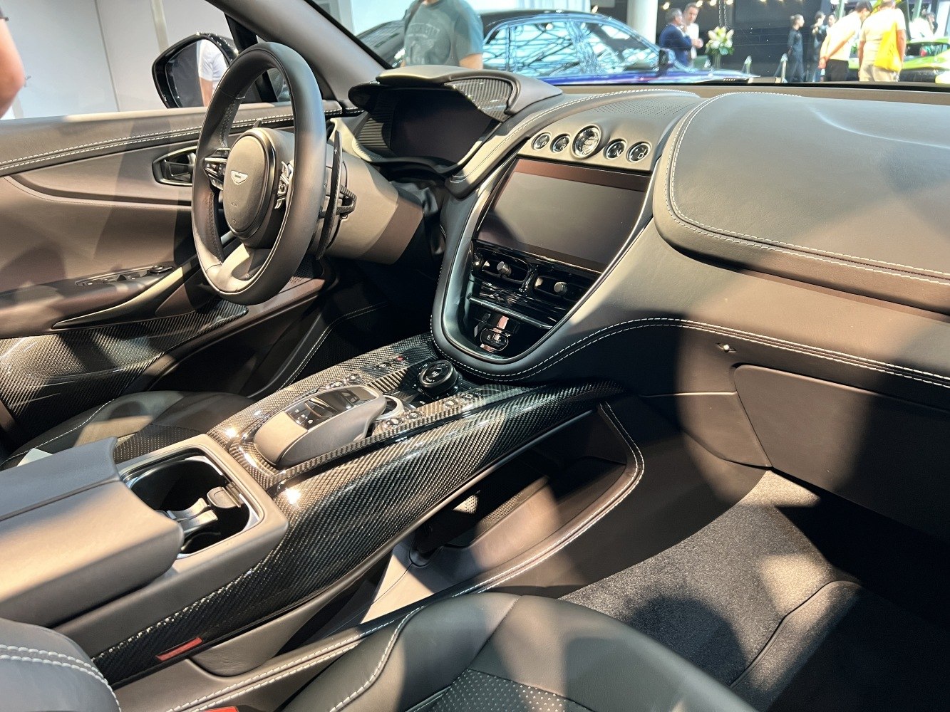 Carbon fiber center console and modern luxury car dashboard with leather stitching