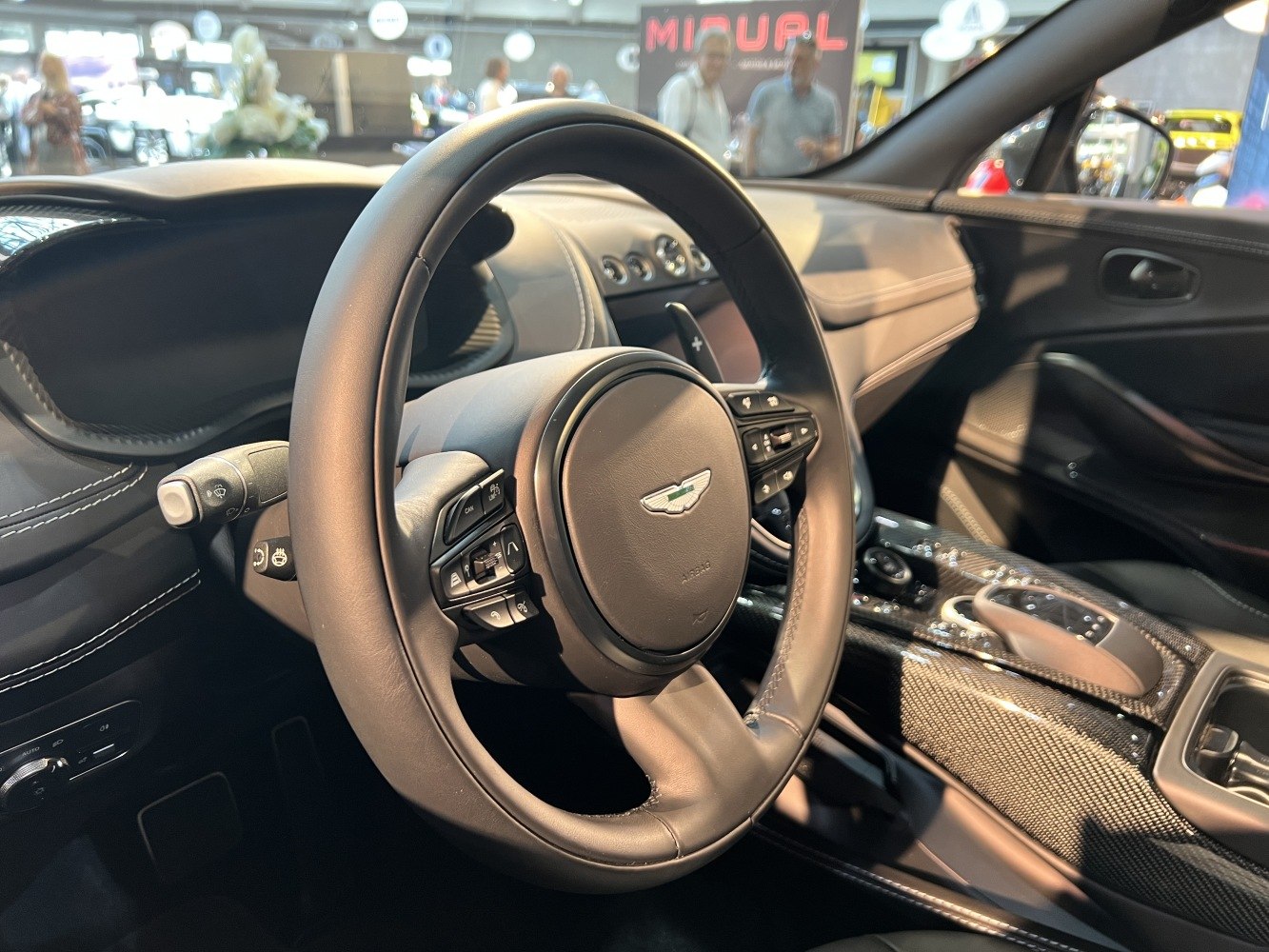 Luxury stitched leather steering wheel and carbon fiber center console interior