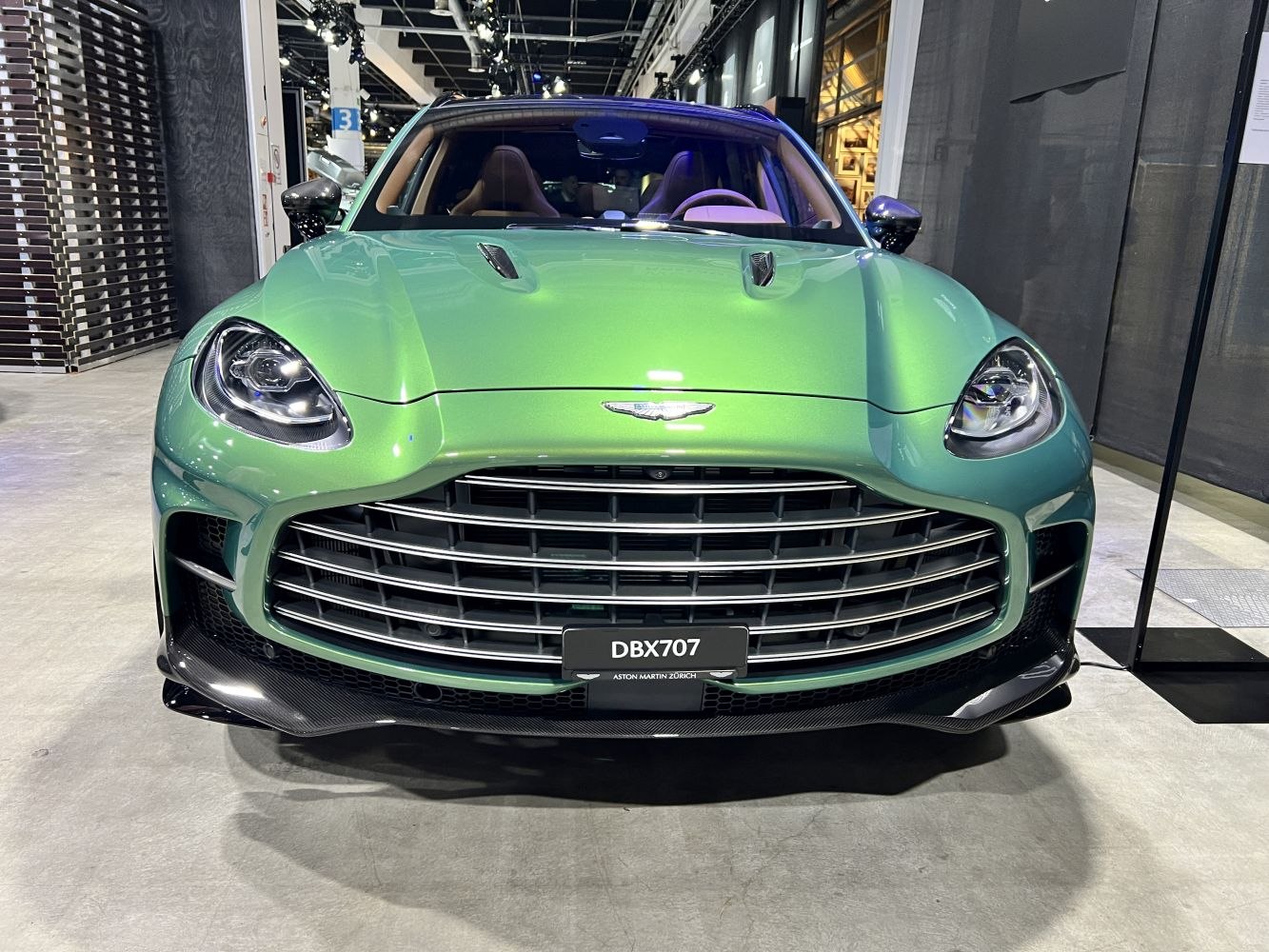 Close-up front view showcasing grille, headlights, and hood vents