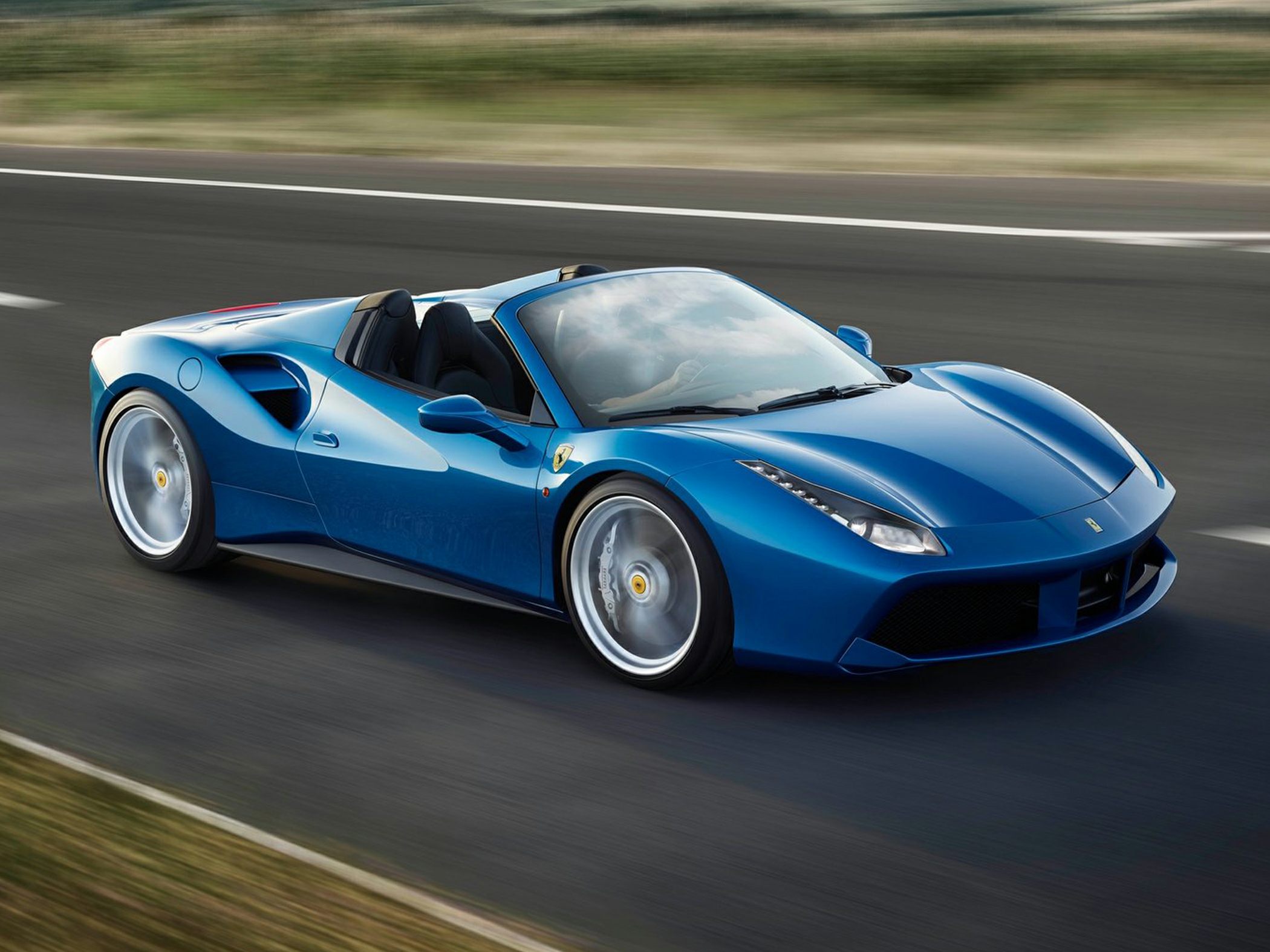 Blue convertible sports car with sleek aerodynamic design and alloy wheels