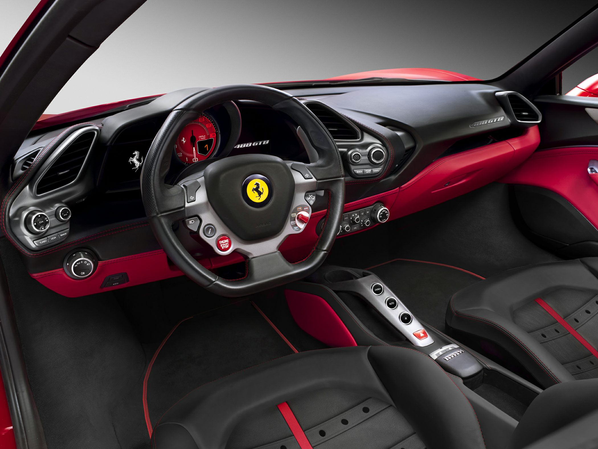 Sporty steering wheel and modern dashboard with red and black interior detailing