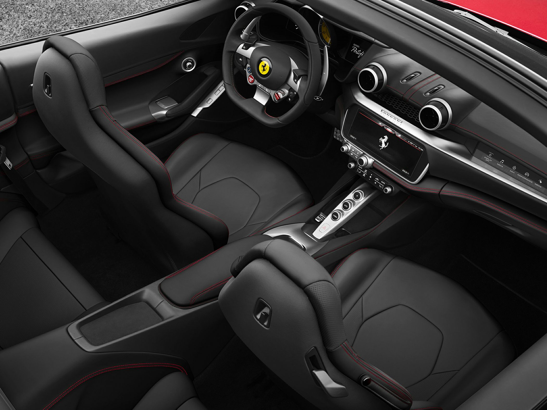 Black leather seats with red stitching, modern dashboard, and advanced steering wheel controls