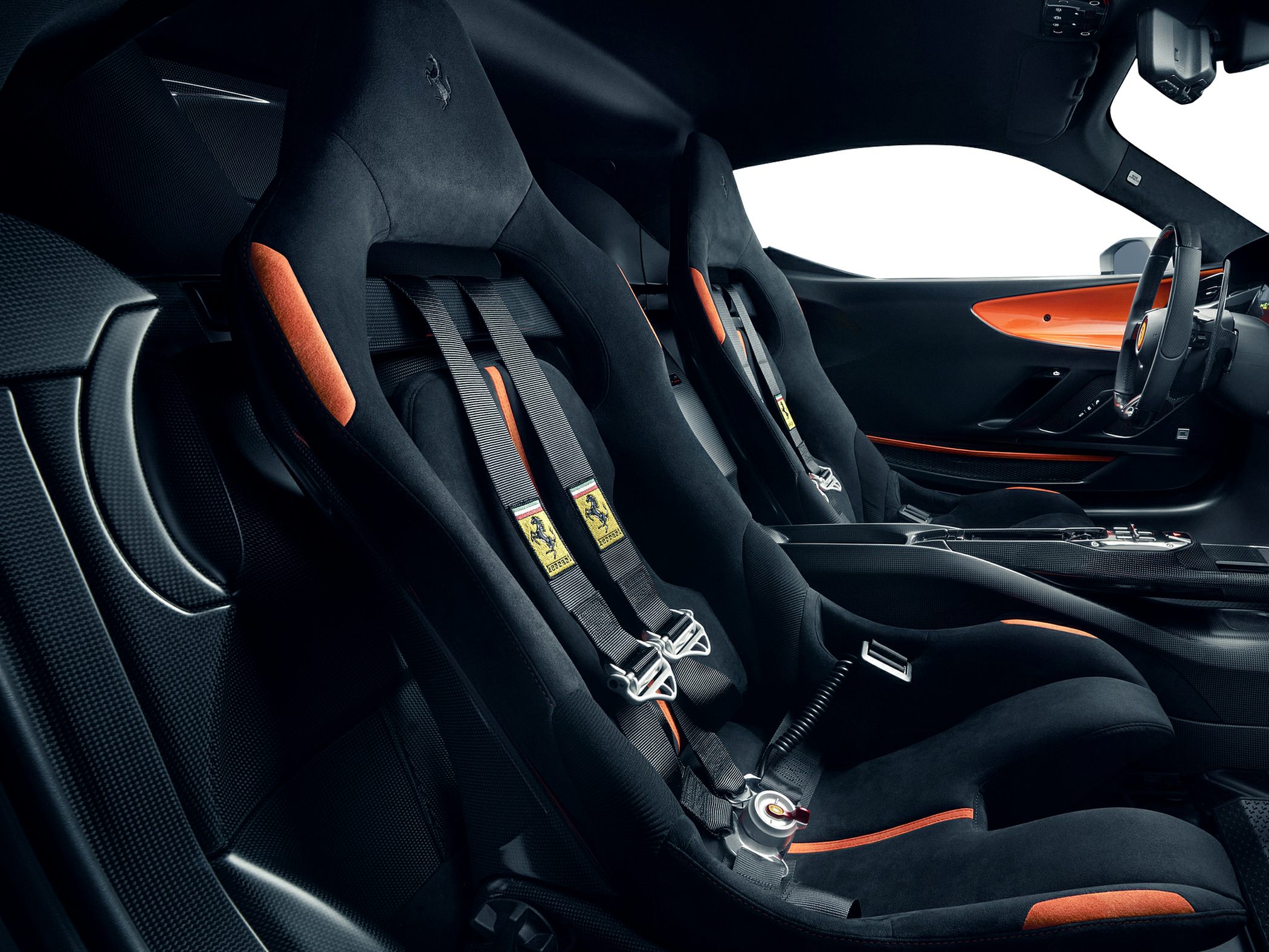 Racing bucket seats with harness and sporty black-orange interior design.