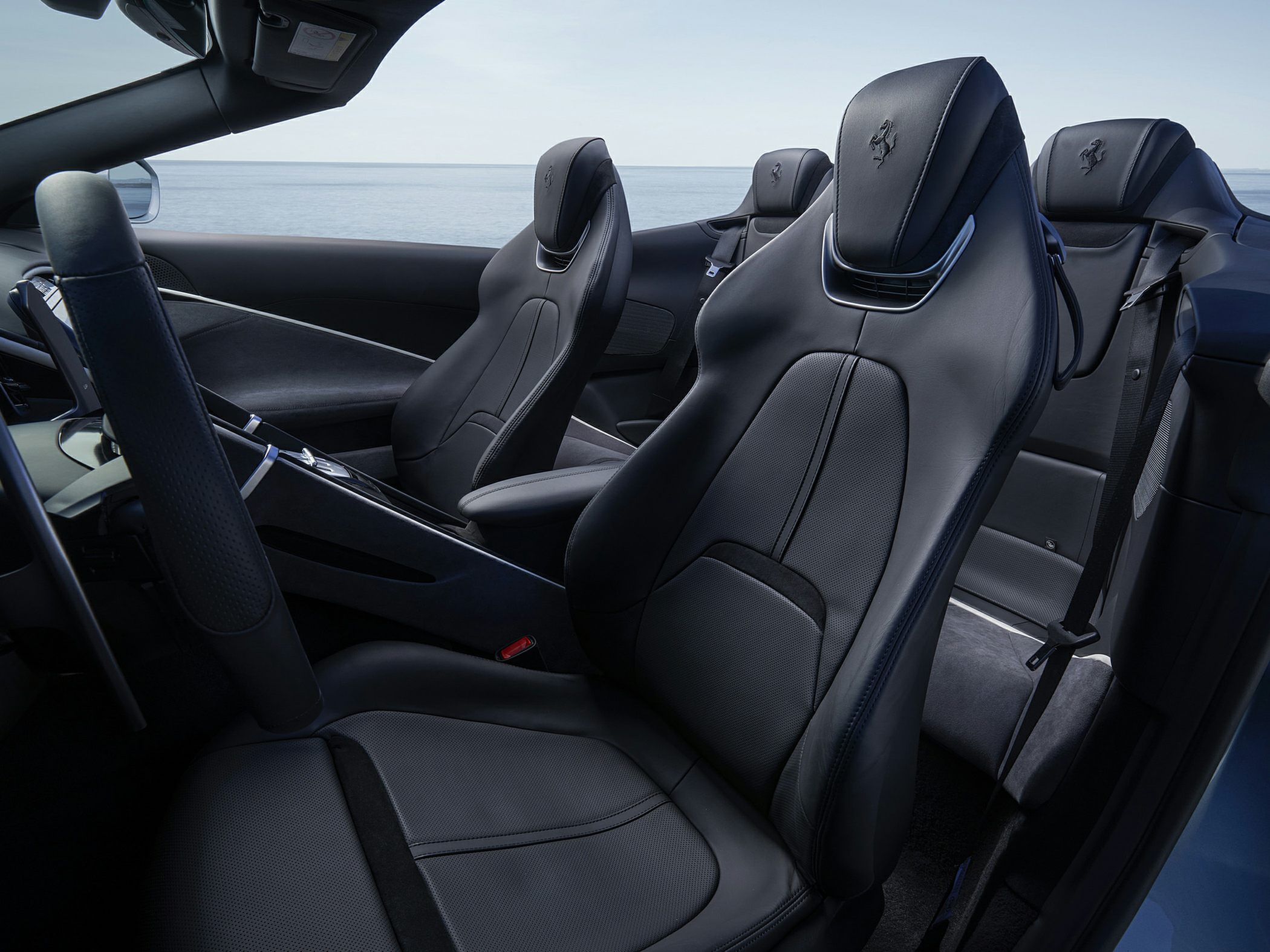 Black leather luxury sportscar seats with Ferrari logo