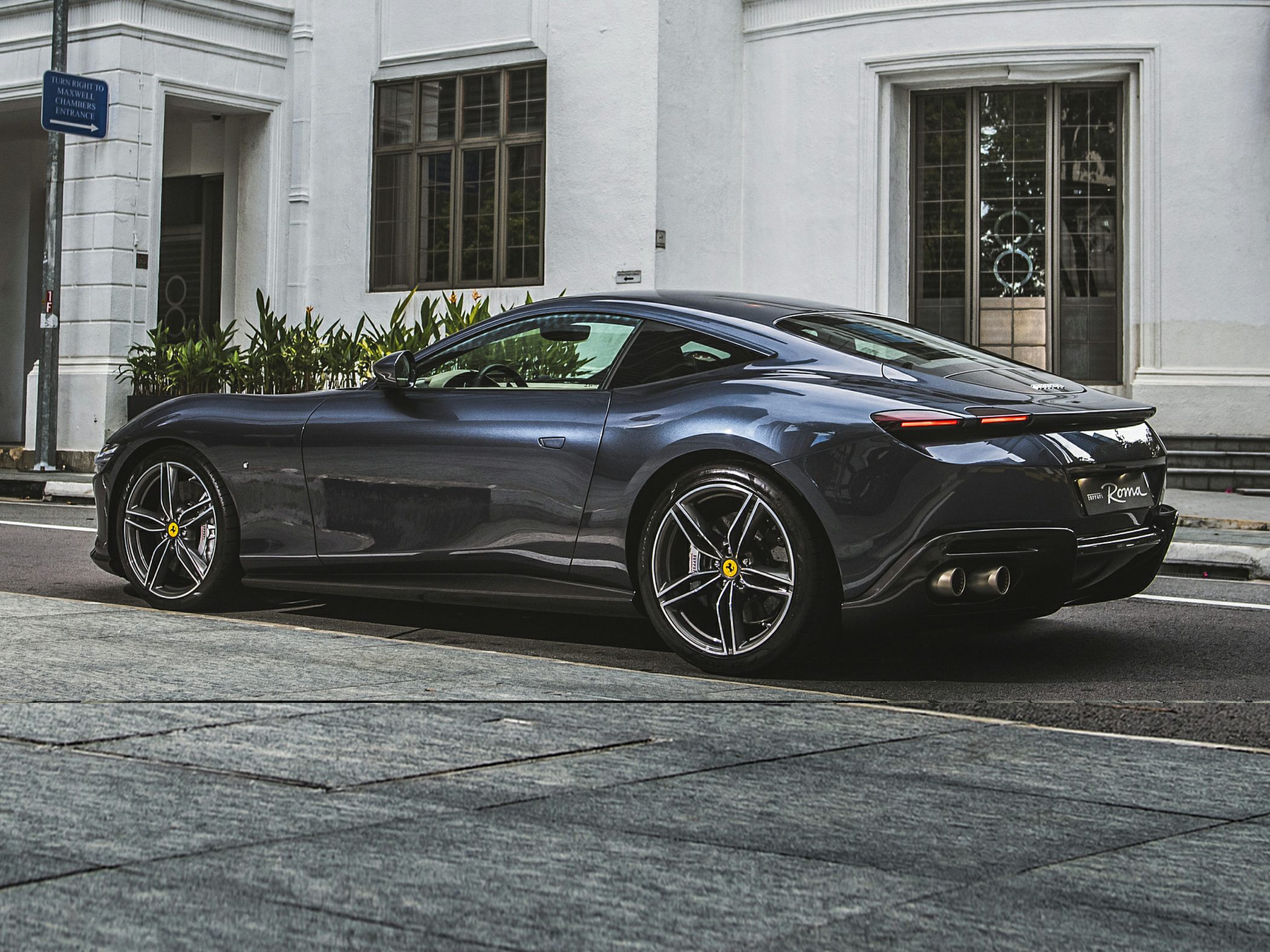 Aerodynamic sleek rear side profile with sporty wheels and dual exhausts